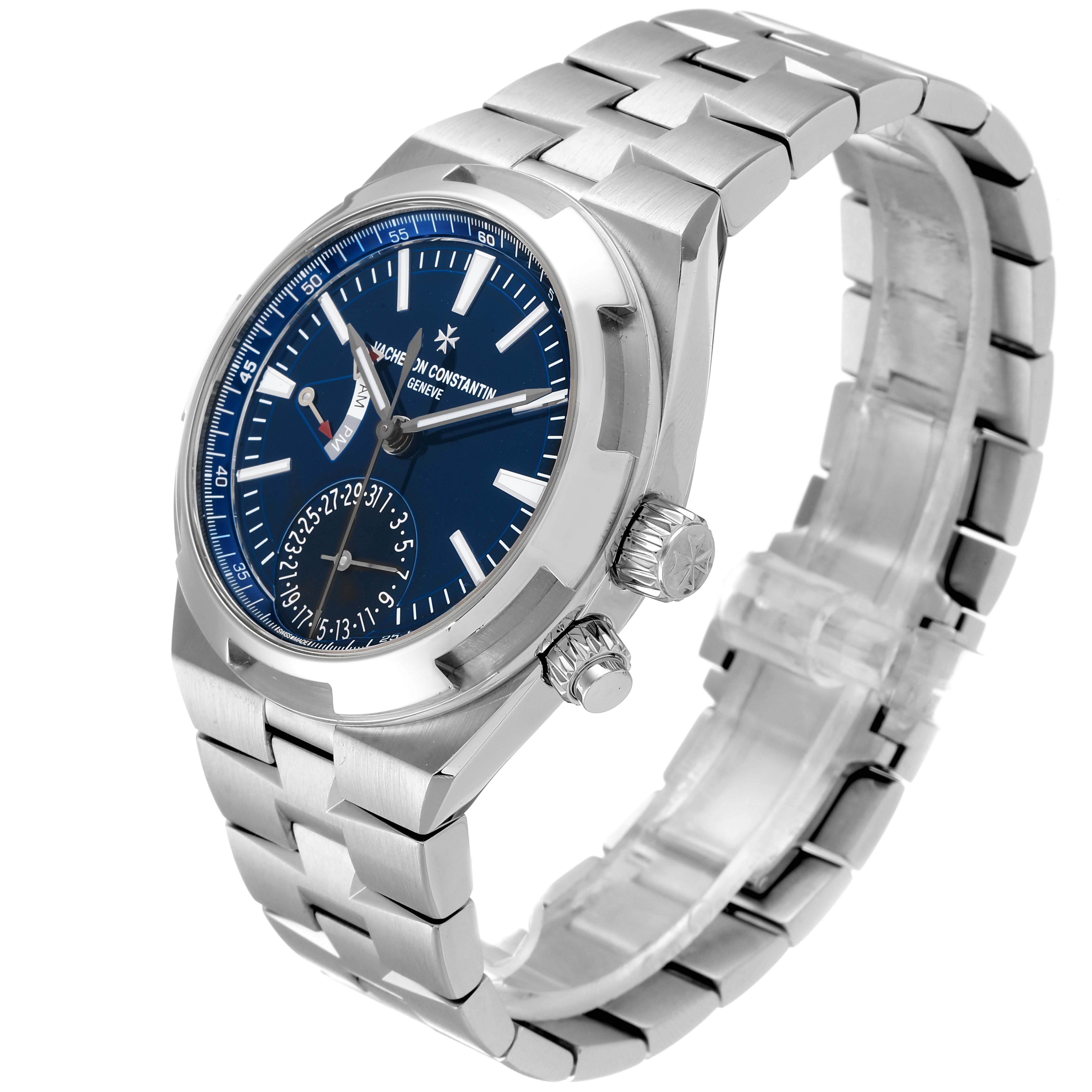 The image shows a Vacheron Constantin Overseas 7900V/110A-B334 Men's Stainless Steel Blue Dial 7900V/110A-B334 Men's Stainless Steel Blue Dial watch at an angle that highlights the face, crown, and stainless steel bracelet.