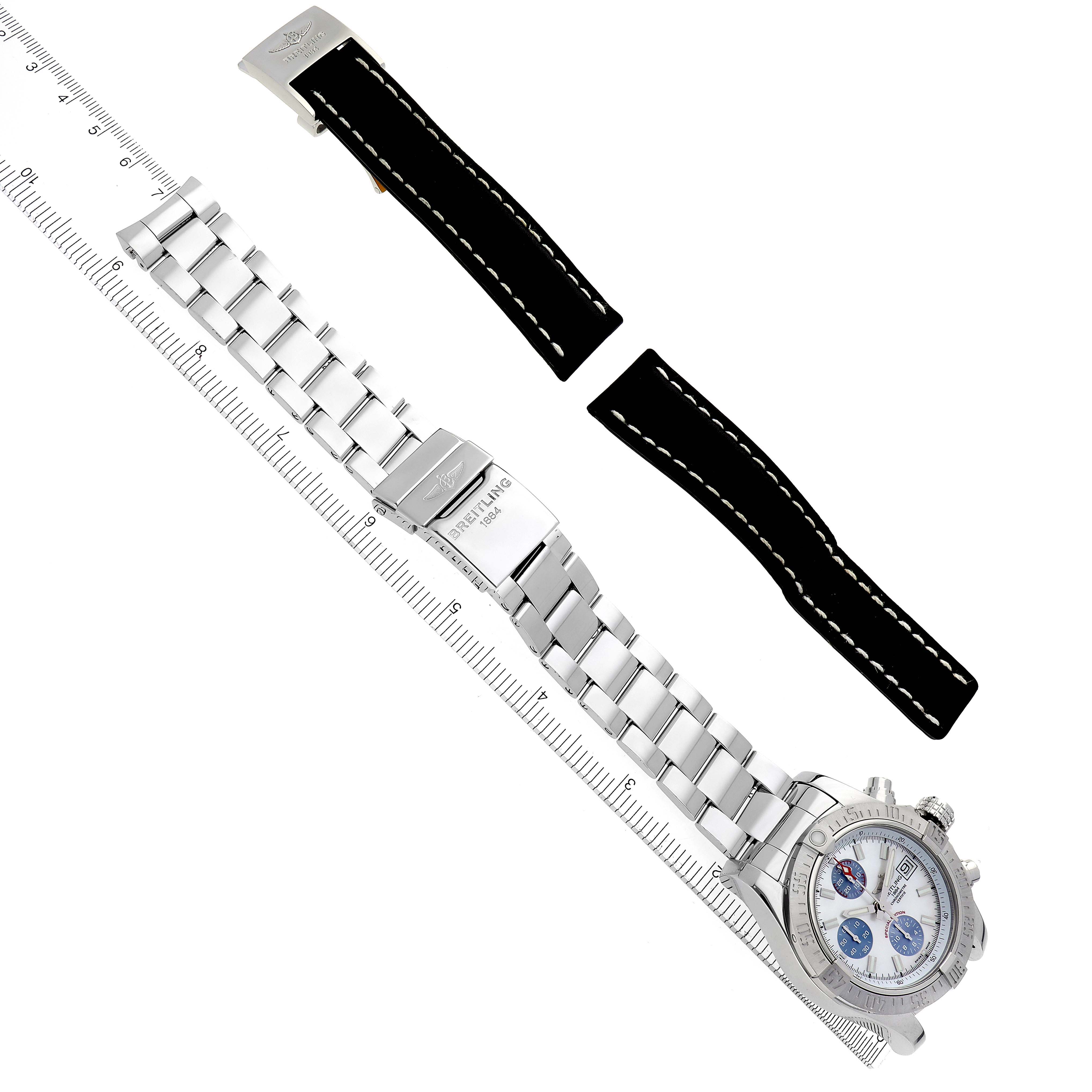 The image shows a Breitling Avenger A1338111/A808 Men's Stainless Steel Mother of Pearl Dial A1338111/A808 Men's Stainless Steel Mother of Pearl Dial watch at a top-down angle with a metal bracelet and black leather straps beside it.