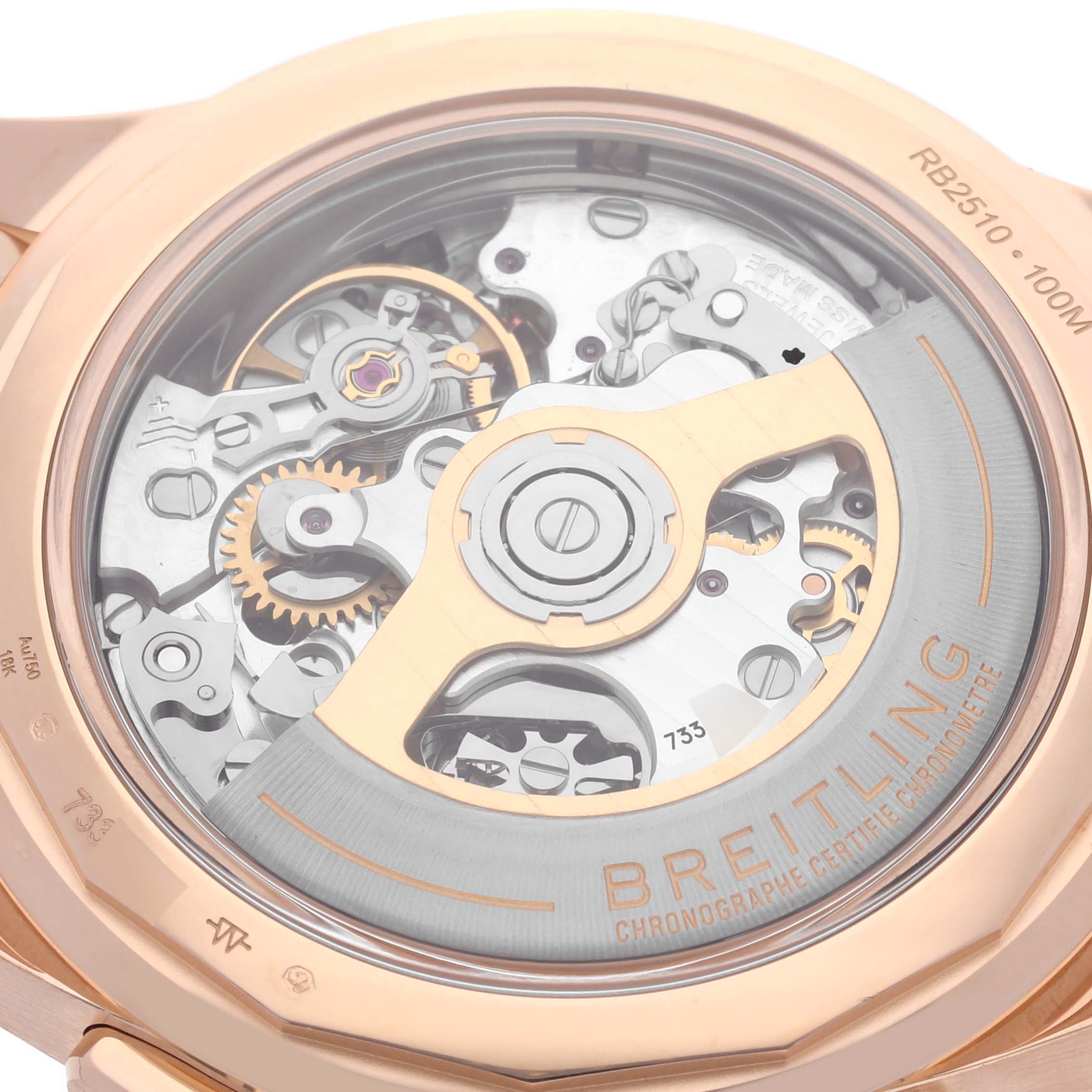 The image shows the back view of a Breitling Premier RB2510 Men's Rose Gold Silver Dial RB2510 Men's Rose Gold Silver Dial watch, highlighting its inner mechanical components and rotor.