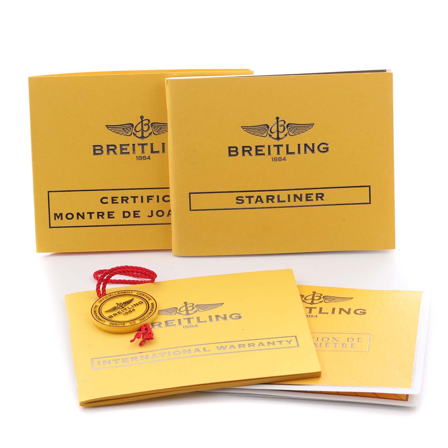 The image shows the Breitling A7134053/B798 Women's Stainless Steel Mother of Pearl Dial A7134053/B798 Women's Stainless Steel Mother of Pearl Dial Starliner model's instruction booklets and warranty papers, not the watch itself.