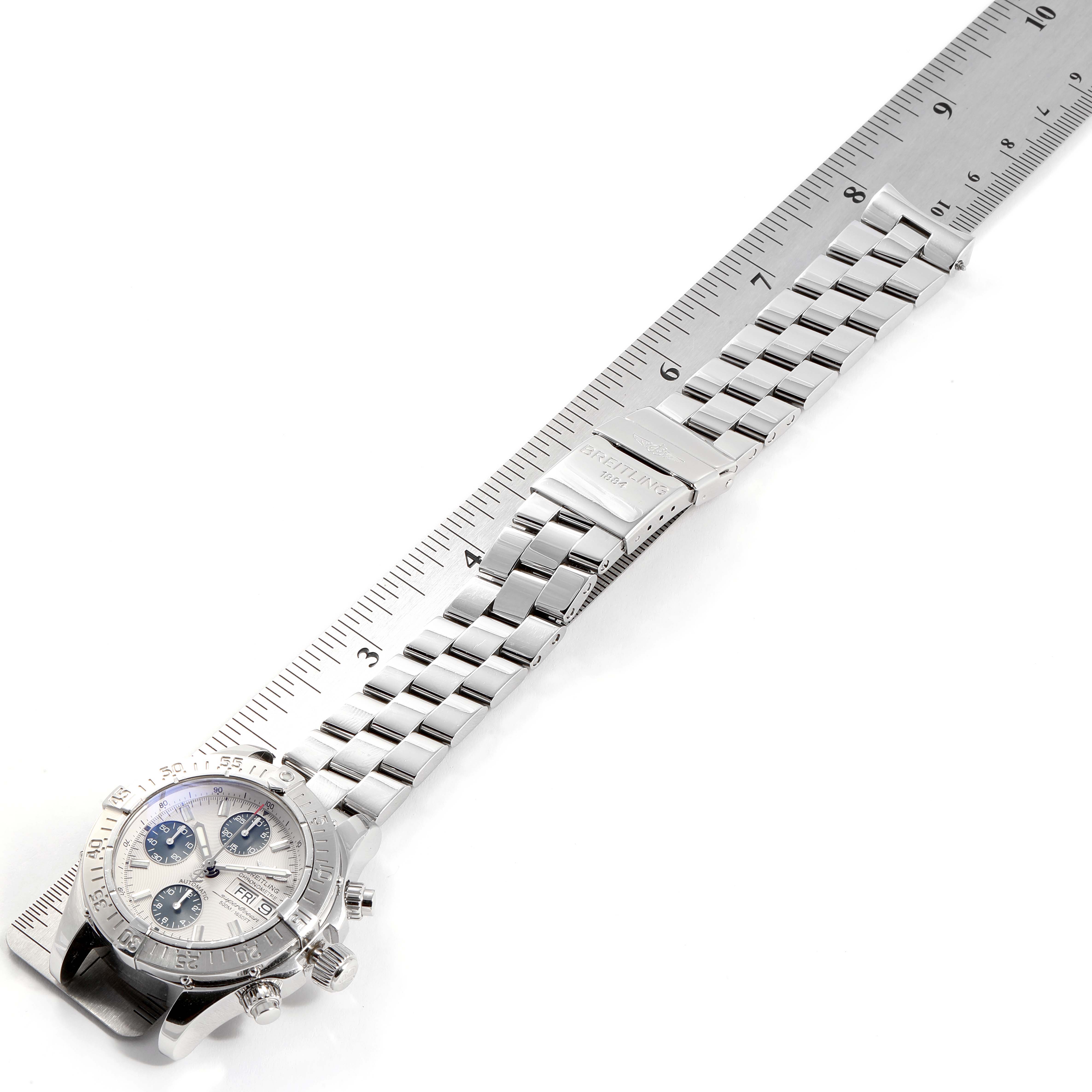 The image shows a Breitling Superocean A13340 Men
s Stainless Steel Beige Dial A13340 Men
s Stainless Steel Beige Dial watch laying flat, measured against a ruler, with its bracelet fully extended.