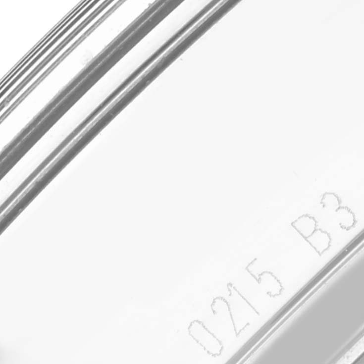 The image shows a close-up of the side of the Breitling Transocean AB0510 Men's Stainless Steel Black Dial AB0510 Men's Stainless Steel Black Dial watch case, highlighting etched numbers on the metal.