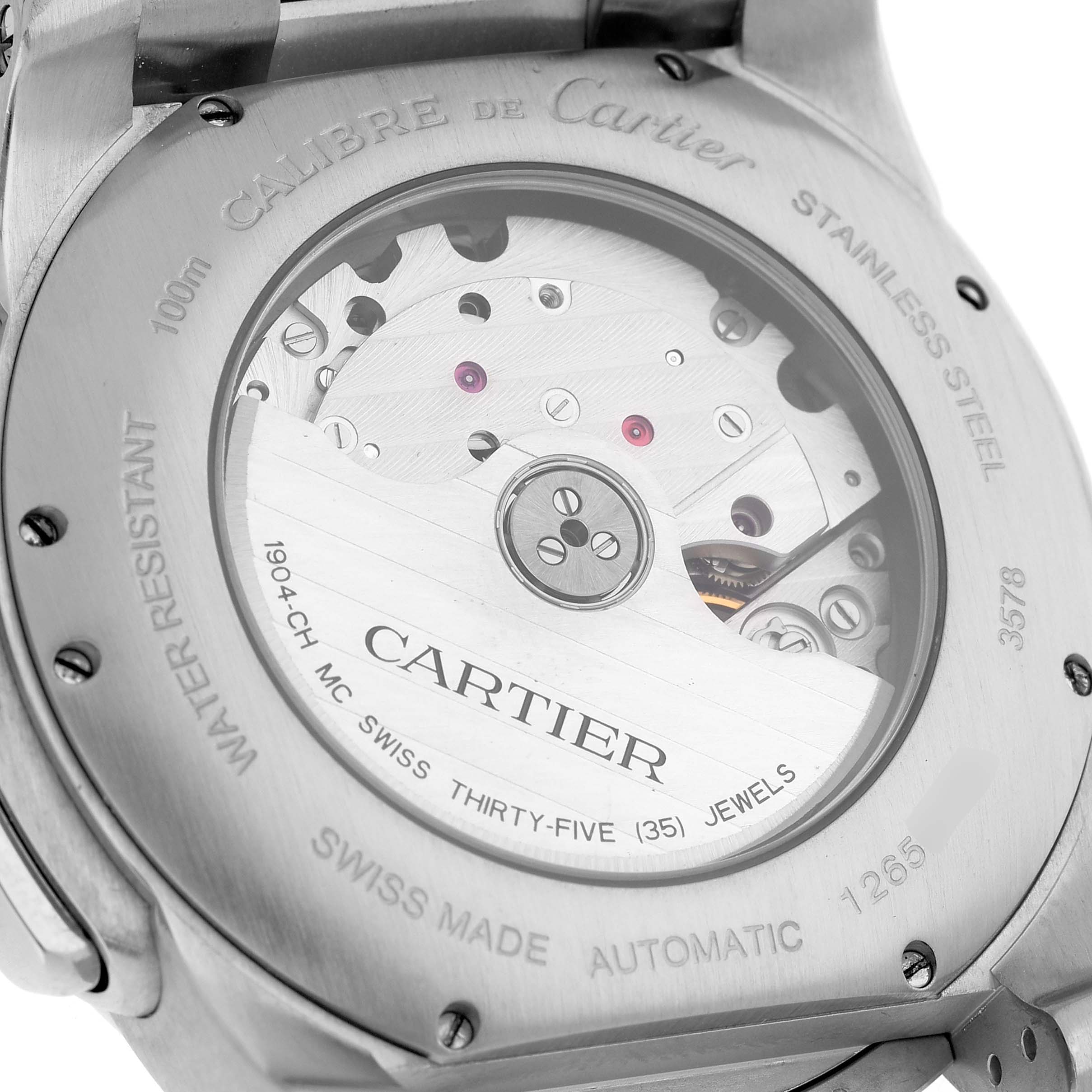 The image shows the back of the Calibre de Cartier watch, displaying its automatic movement and engravings.