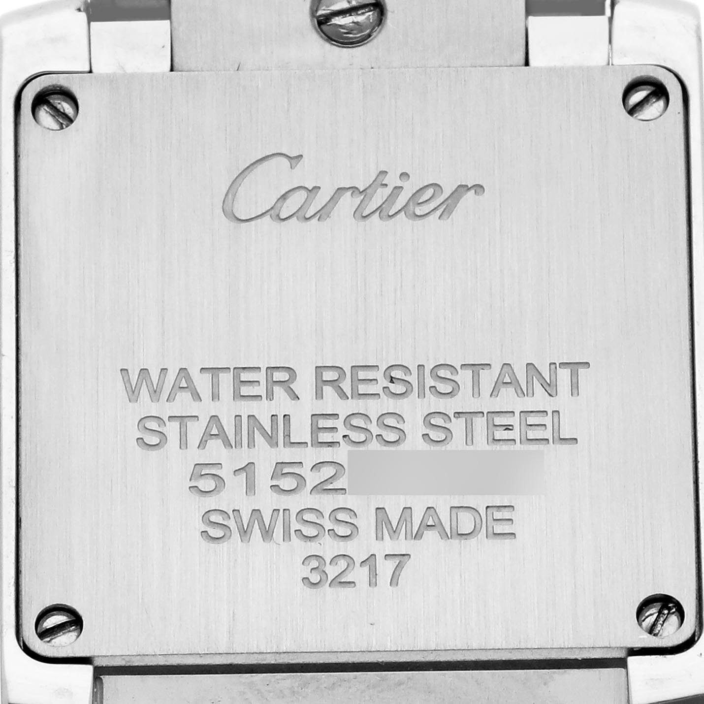 The image shows the stainless steel back of a Cartier Tank Française watch engraved with brand details and specifications.