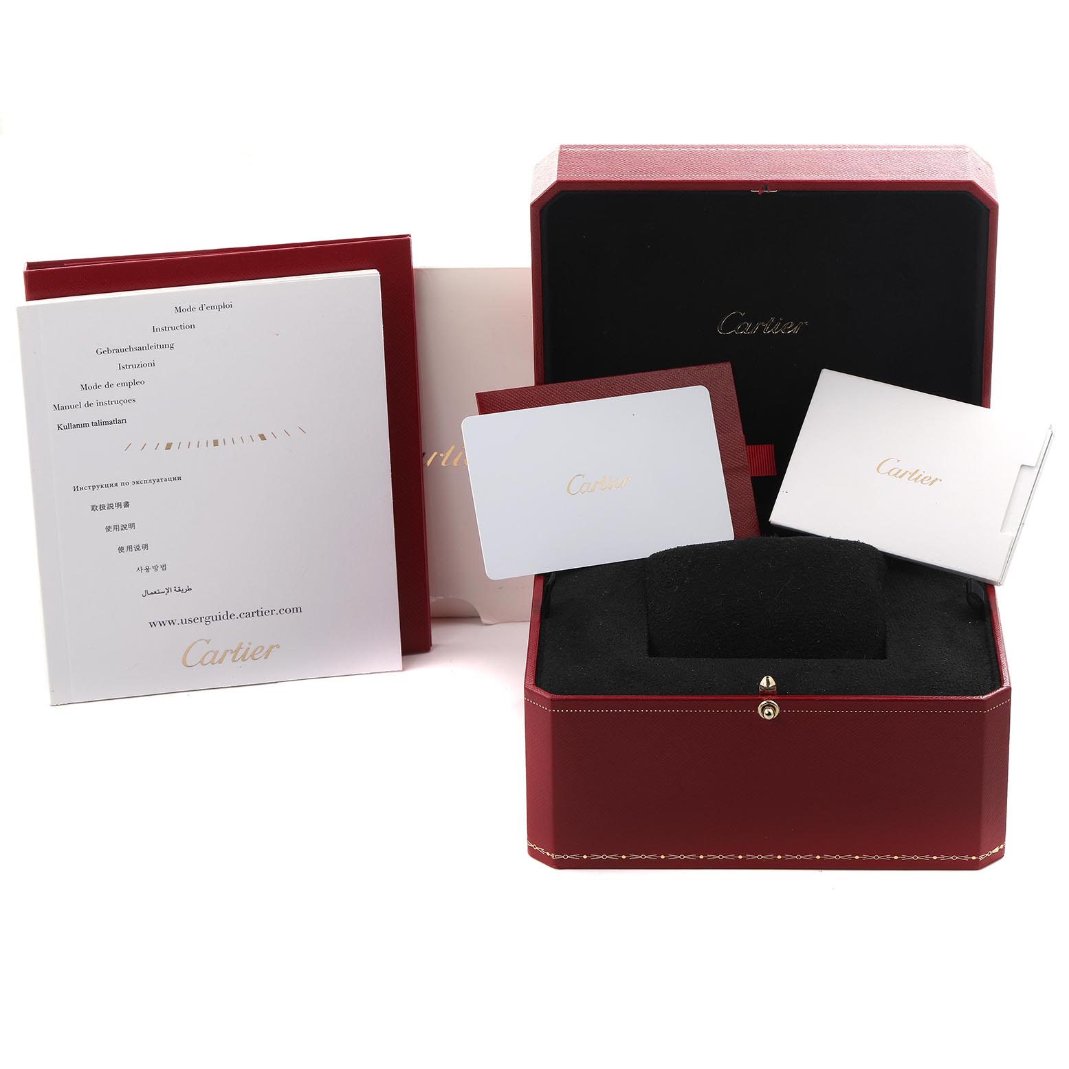 The image shows a Cartier Tank Française box with a black cushion and several instruction booklets and cards.