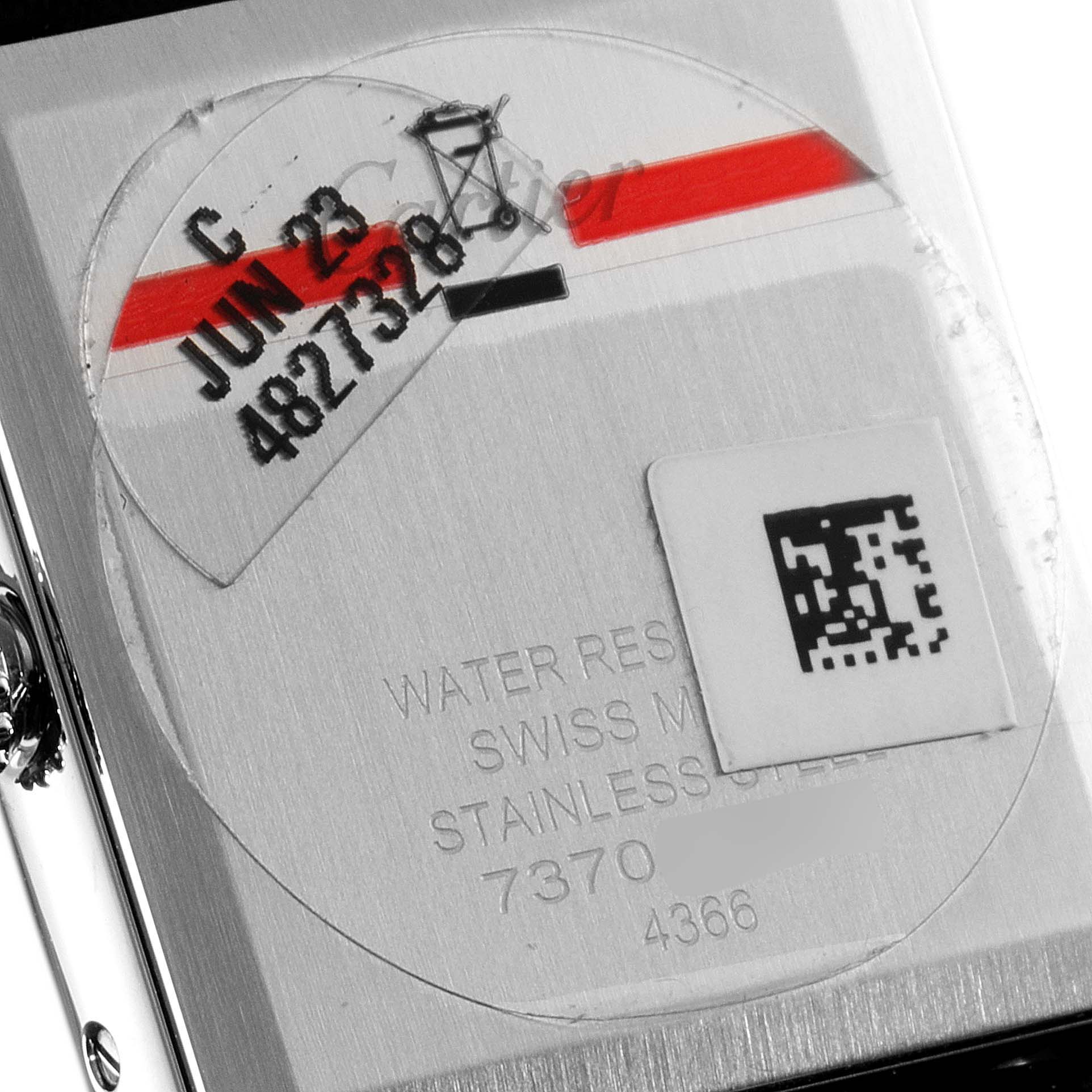 This image shows the back case of a Cartier Tank Must WSTA0059 Men's Stainless Steel Silver Dial WSTA0059 Men's Stainless Steel Silver Dial watch, displaying serial numbers and manufacturing details.