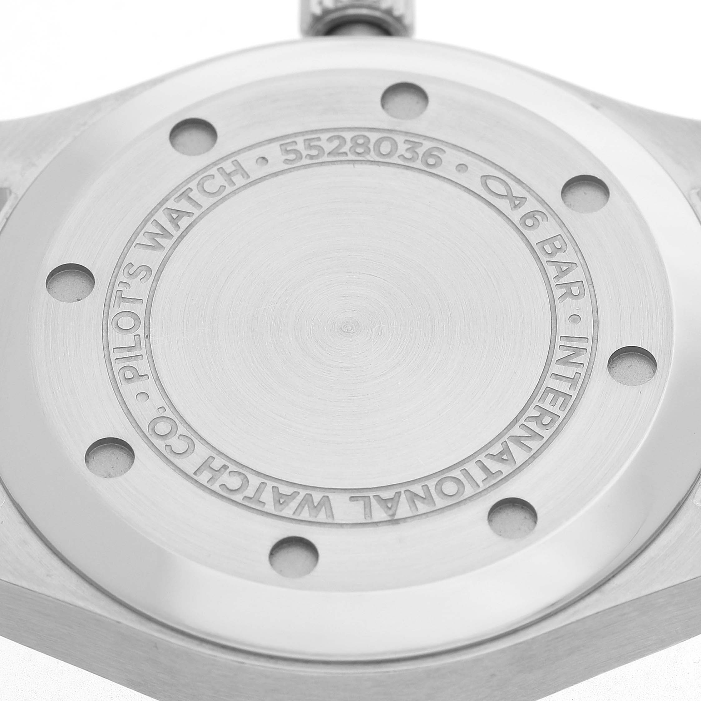The image shows the back case of the IWC Pilot IW324006 Men's Stainless Steel Silver Dial's Watch at a straight angle, highlighting its engravings and screw holes.
