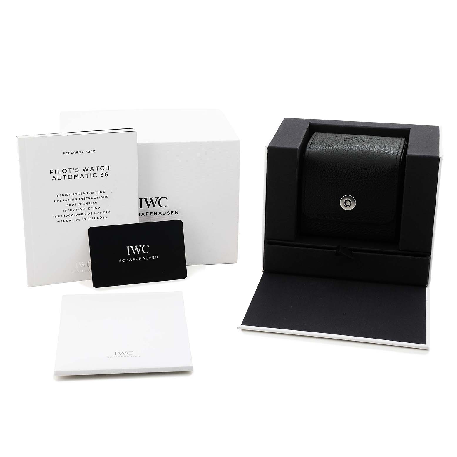 The image shows the IWC Pilot IW324006 Men's Stainless Steel Silver Dial's Watch Automatic 36 box, instruction booklet, and warranty card from a top angle.