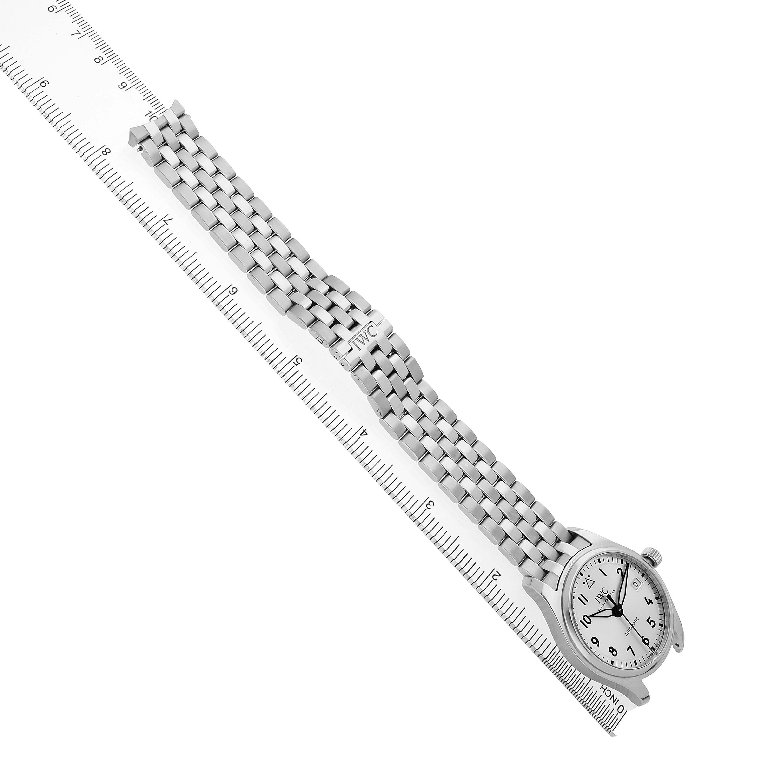 The IWC Pilot IW324006 Men's Stainless Steel Silver Dial model watch is shown from a top-down angle, displaying its metal bracelet and face with a ruler for scale.