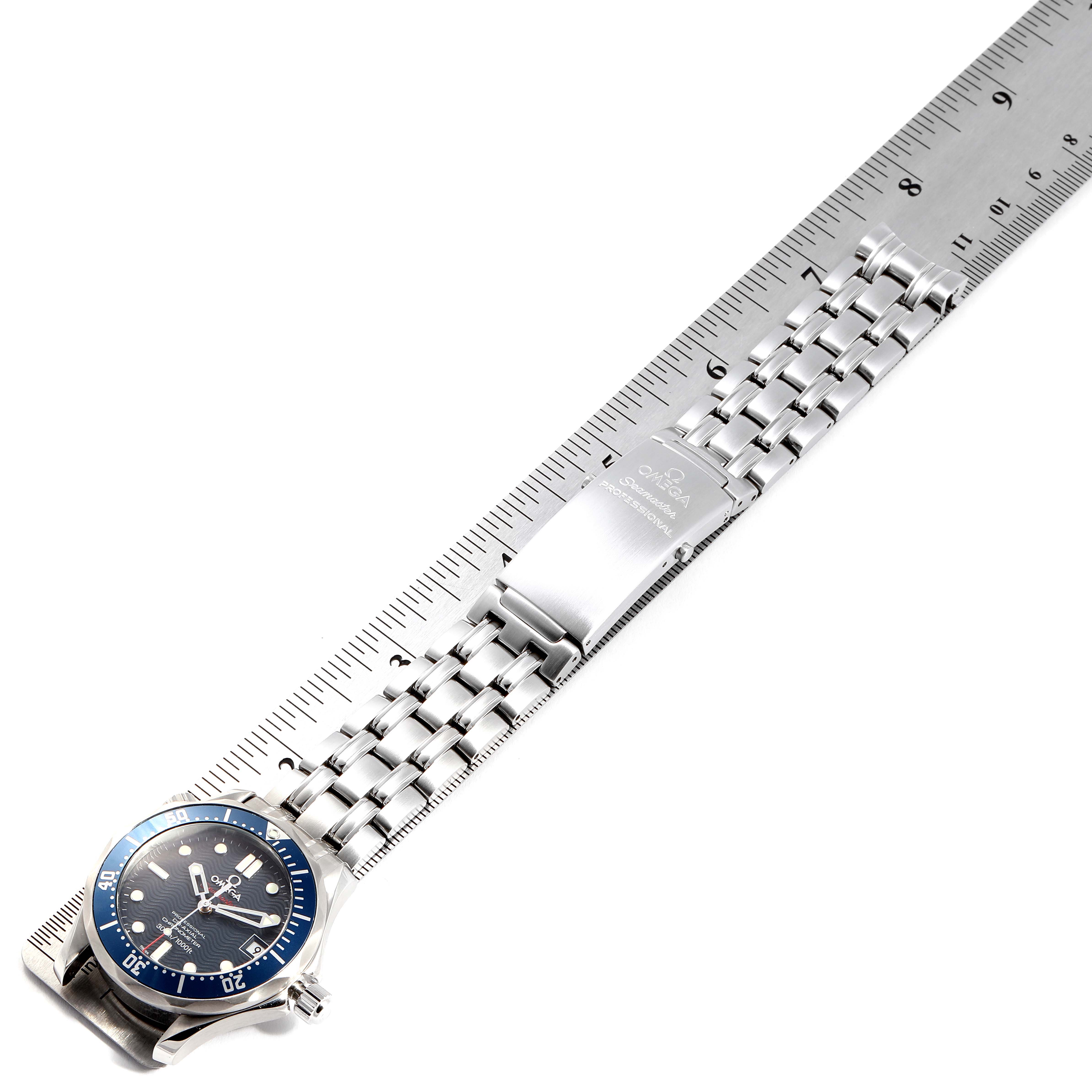The image shows an Omega Seamaster 2222.80.00 Men
s Stainless Steel Blue Dial 2222.80.00 Men
s Stainless Steel Blue Dial watch laid flat, displaying the face, bezel, bracelet, and clasp next to a ruler for scale.