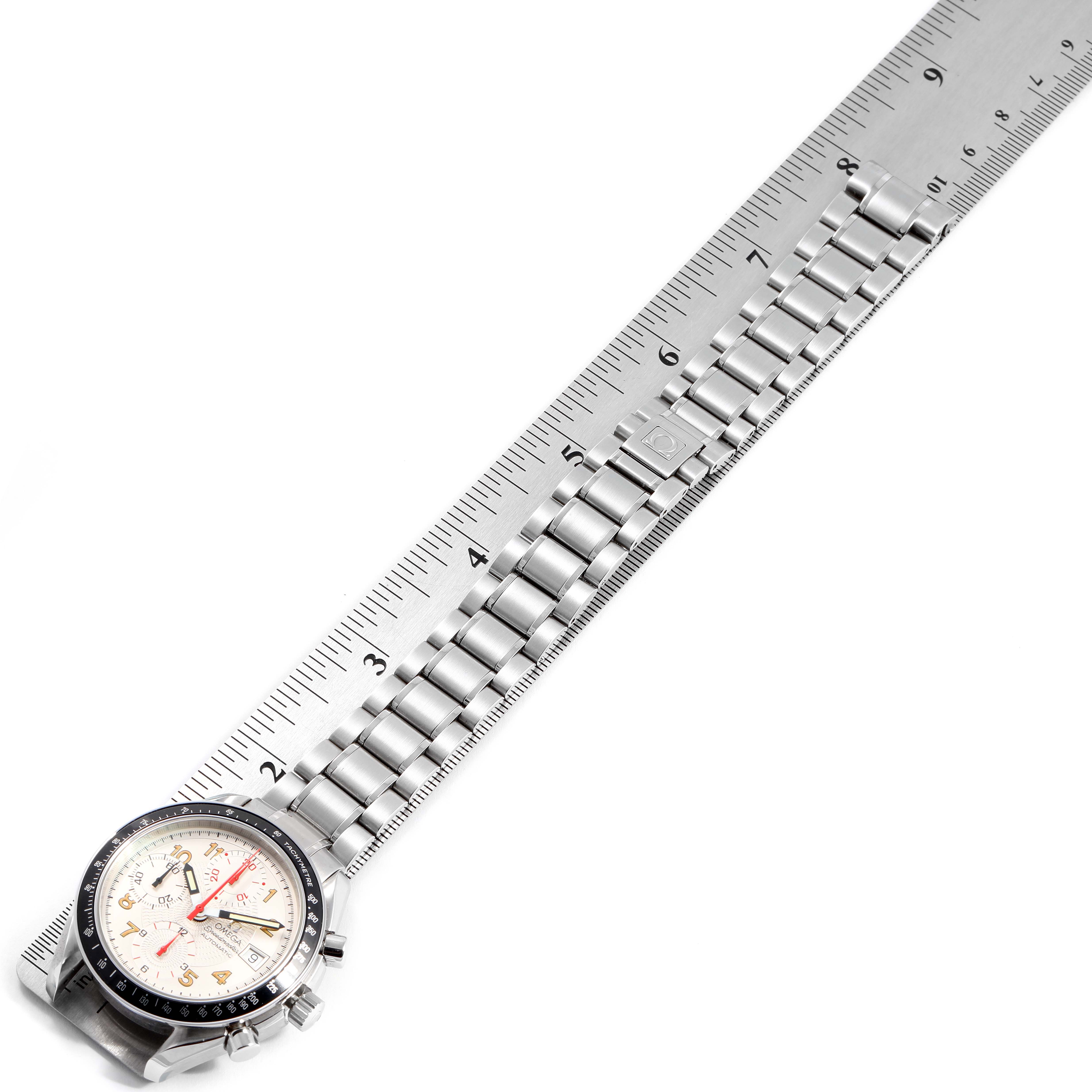 This image shows an Omega Speedmaster 3513.33.00 Men's Stainless Steel White Dial 3513.33.00 Men's Stainless Steel White Dial watch with a metal bracelet, aligned next to a ruler.