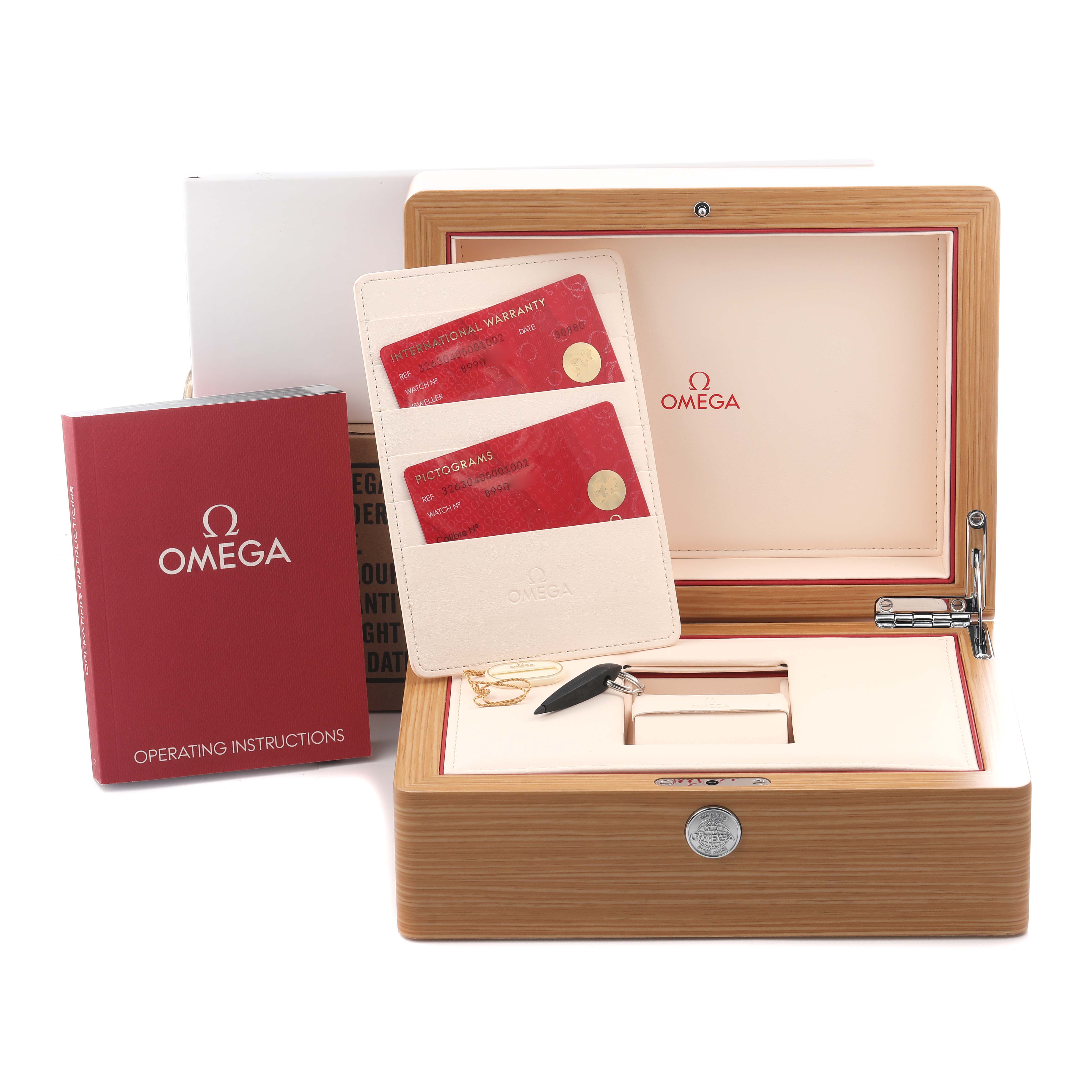 The image shows an Omega Speedmaster 326.30.40.50.01.002 Men's Stainless Steel Black Dial 326.30.40.50.01.002 Men's Stainless Steel Black Dial watch box set with documents and key accessories at an angle displaying the interior and items.