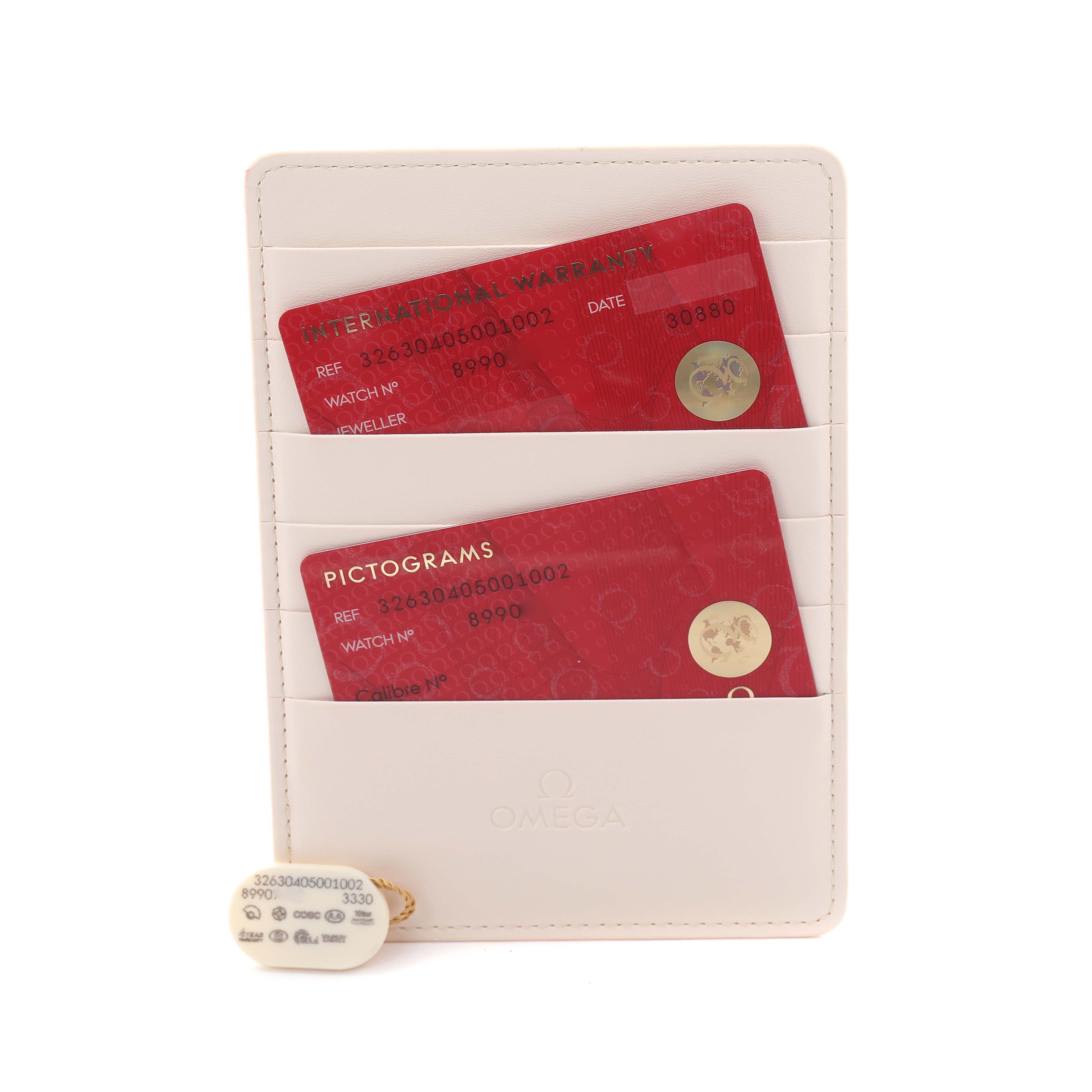 The image shows Omega Speedmaster 326.30.40.50.01.002 Men's Stainless Steel Black Dial 326.30.40.50.01.002 Men's Stainless Steel Black Dial cards and tags, including warranty and pictograms, in a holder.