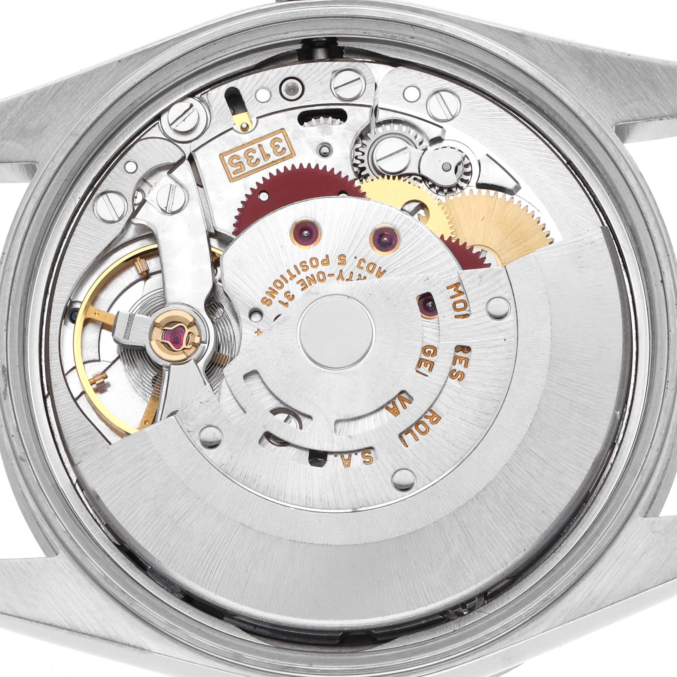 The image shows the movement of a Rolex Date 15210 Men
s Stainless Steel Blue Dial 15210 Men
s Stainless Steel Blue Dial watch from the back, highlighting gears and components in a polished case.