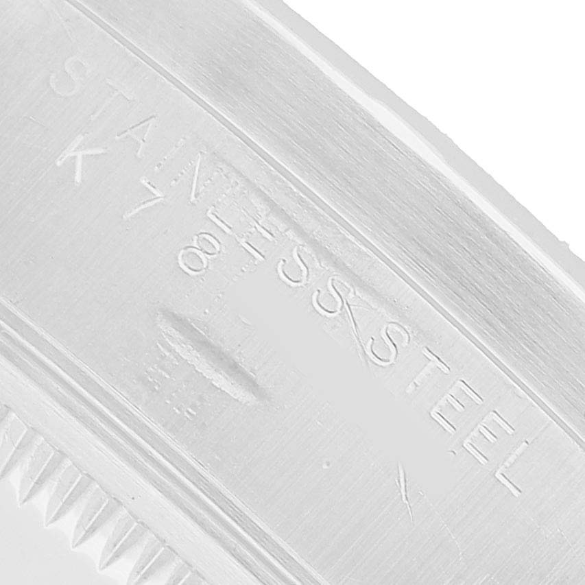 The image shows a close-up of the side engraving on a stainless steel Rolex Date 15210 Men's Stainless Steel Pink Dial model, highlighting the material details.
