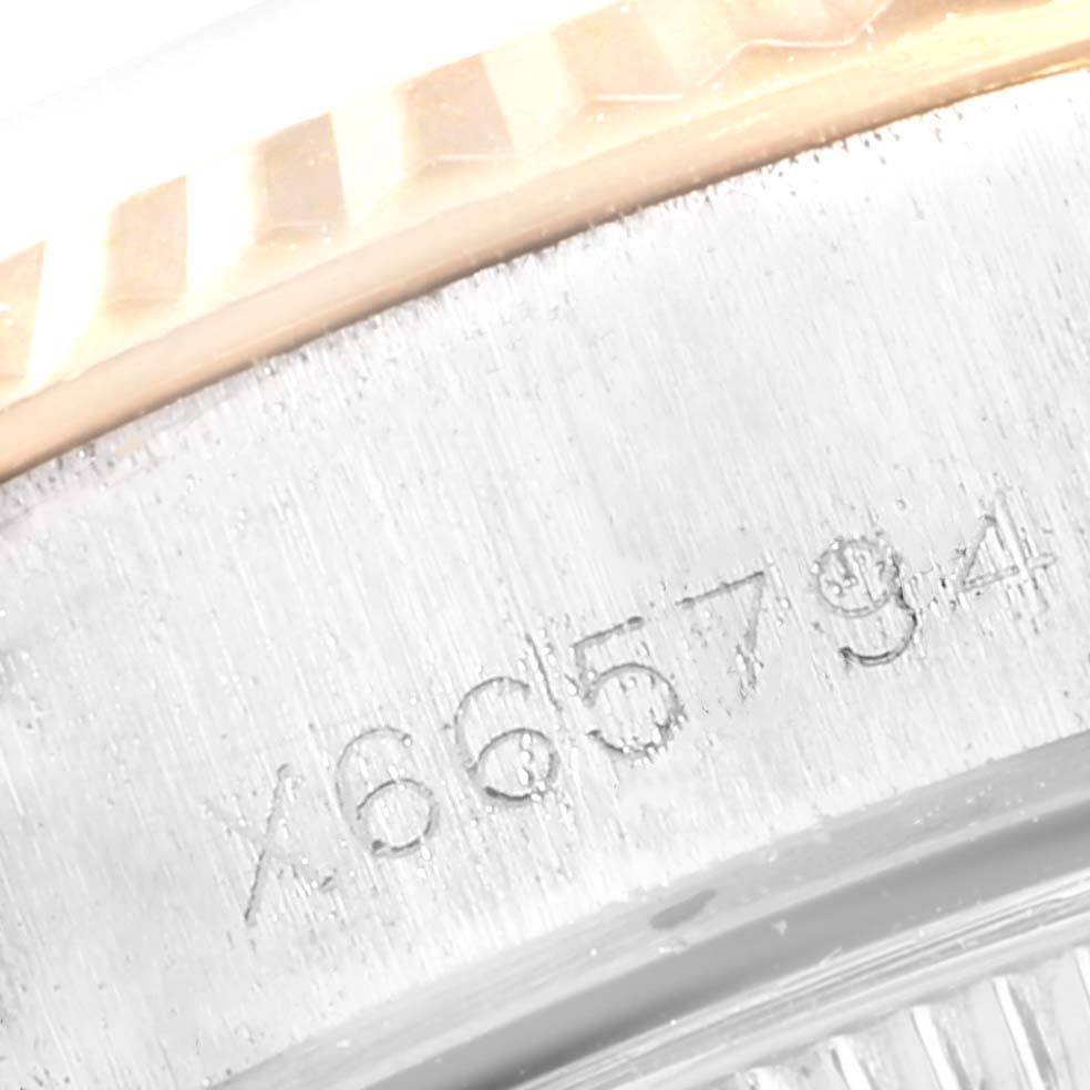 This close-up image shows the serial number engraved on the side of a Rolex Datejust 69173 Women
s Steel and Gold (two tone) Silver Dial 69173 Women
s Steel and Gold (two tone) Silver Dial watch case.