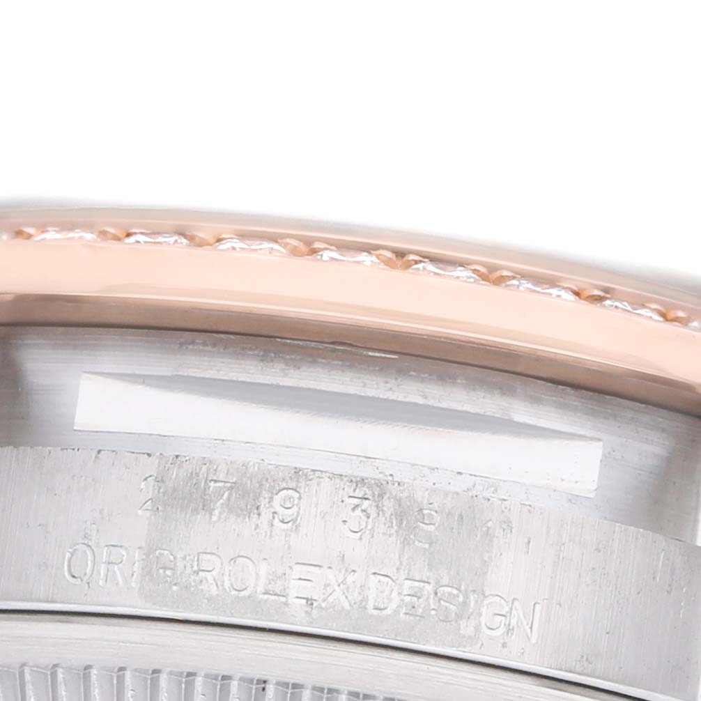 The image shows a close-up of the case edge and bezel of a Rolex Datejust 279381 Women's Steel and Gold (two tone) Brown Dial watch, highlighting the engraving and design details.