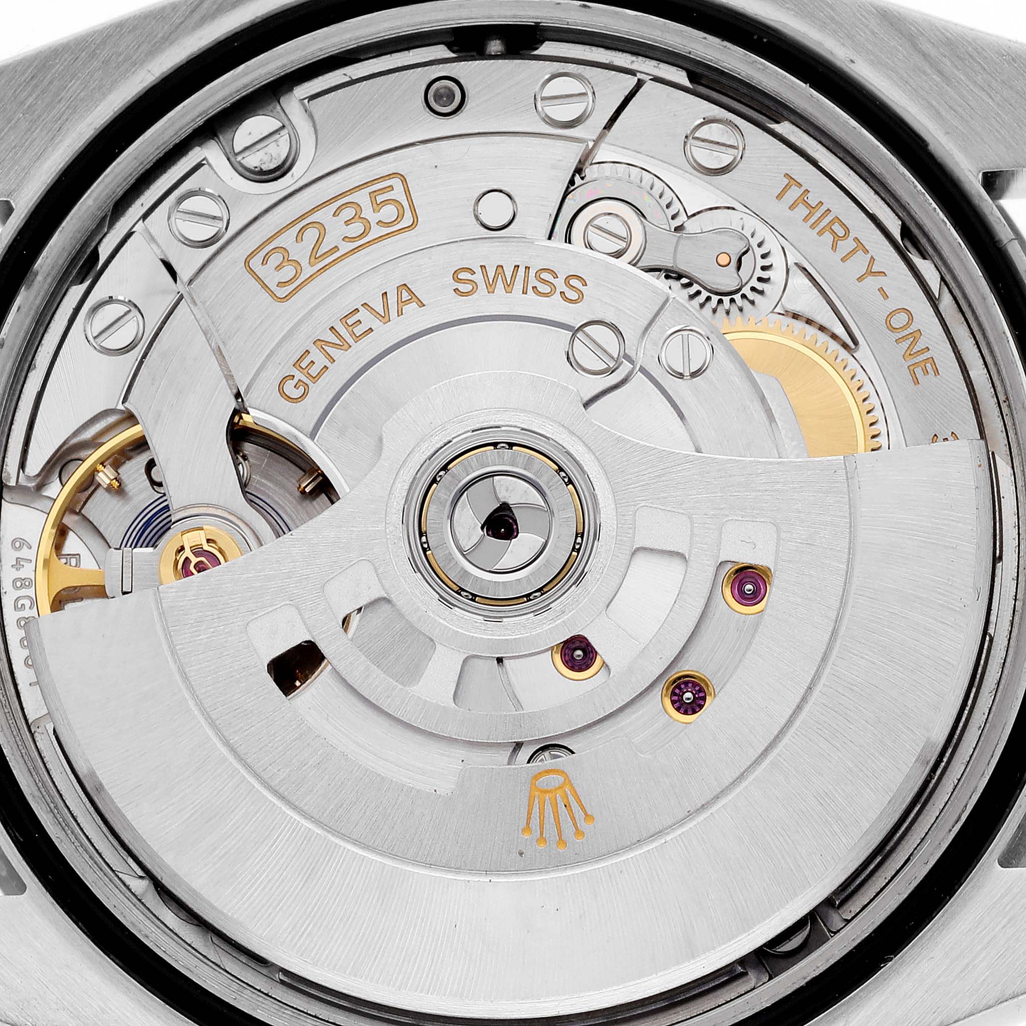 The image shows a close-up view of the movement inside a Rolex Datejust 126231 Men's Steel and Gold (two tone) Grey Dial 126231 Men's Steel and Gold (two tone) Grey Dial watch, highlighting the intricate gears and rotor.