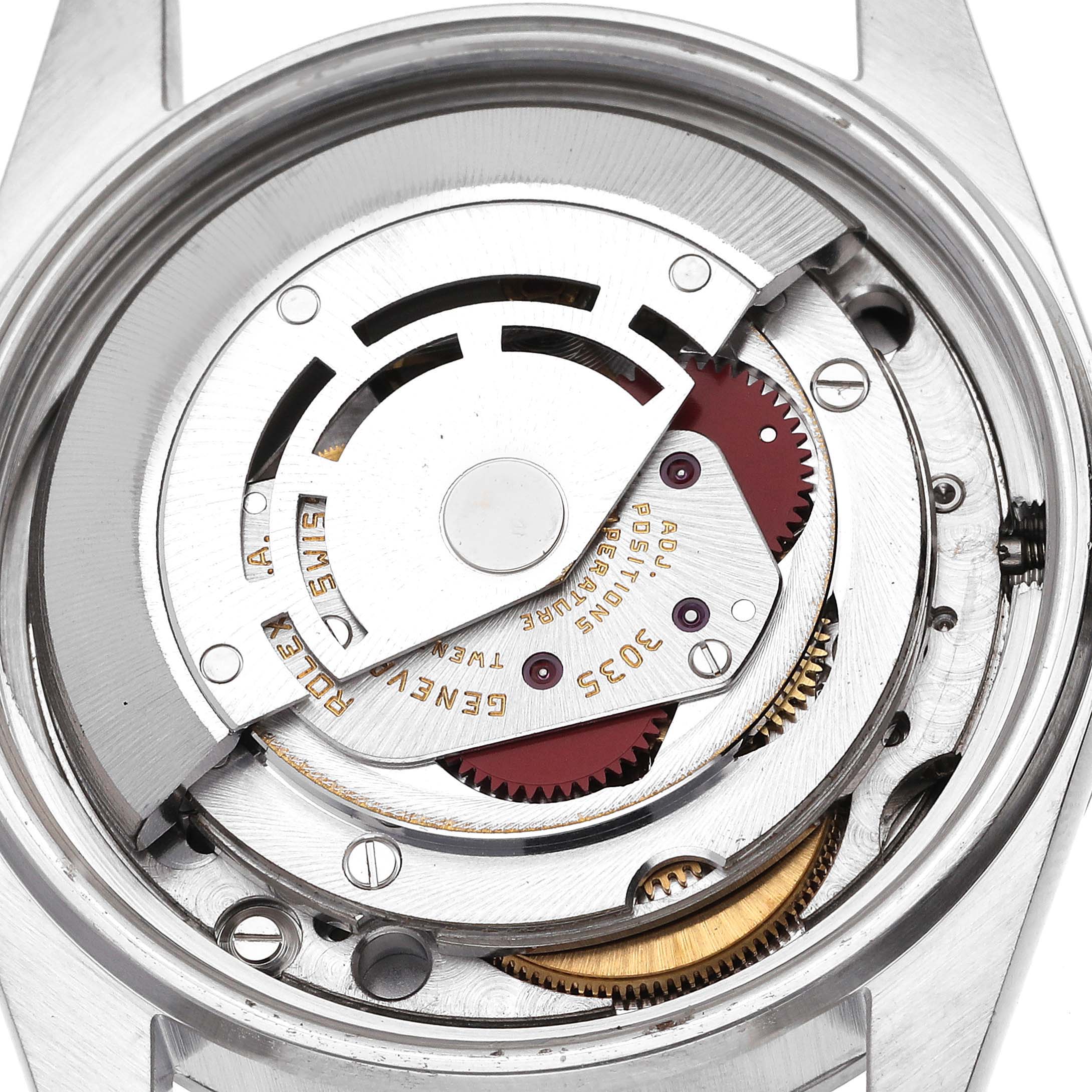 The image shows the movement mechanism of a Rolex Datejust 16000 Men's Stainless Steel White Dial 16000 Men's Stainless Steel White Dial watch from the back, highlighting gears and engravings.