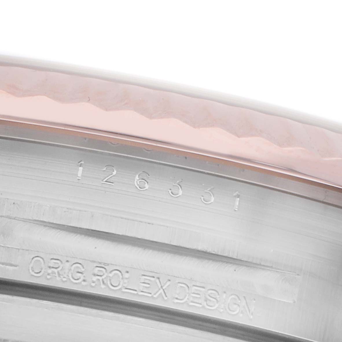 The image shows a close-up of the inner case edge and bezel of a Rolex Datejust 41 126331 Men
s Steel and Gold (two tone) Pink Dial 126331 Men
s Steel and Gold (two tone) Pink Dial, displaying engravings and design details.
