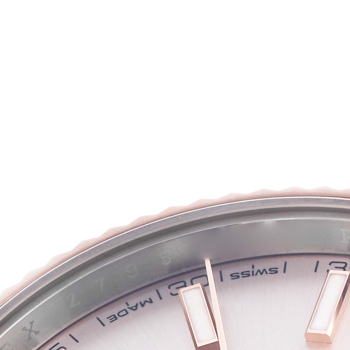 The image shows a close-up of the dial and bezel of the Rolex Datejust 41 126331 Men
s Steel and Gold (two tone) Pink Dial 126331 Men
s Steel and Gold (two tone) Pink Dial, focusing on hour markers and part of the "Swiss Made" text.