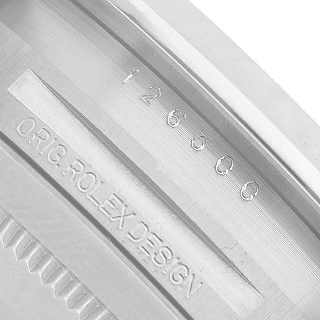 The image shows a close-up of the inner bezel of the Rolex Datejust 41 126300 Men's Stainless Steel White Dial, displaying model numbers and design text.