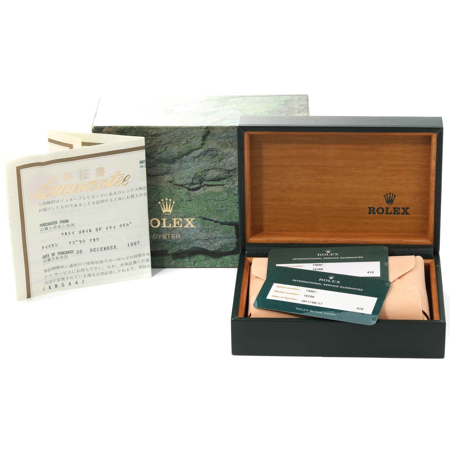 The image shows an open Rolex watch box with documents and a guarantee card for a Datejust model.