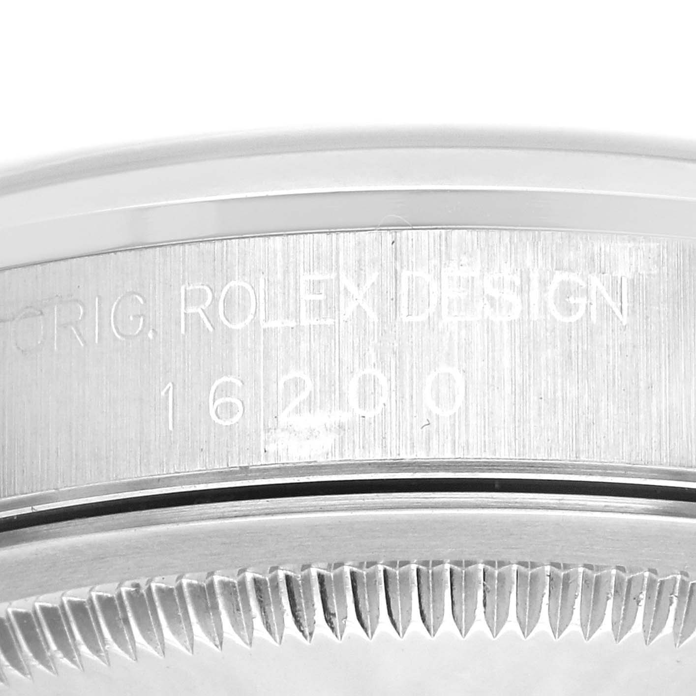 The image shows a close-up of the engraved side of the casing and part of the bezel of a Rolex Datejust 16200 Men's Stainless Steel Blue Dial 16200 Men's Stainless Steel Blue Dial watch.