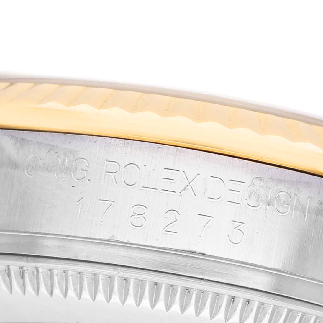 The image shows a close-up side view of the bezel and engraved serial number of a Rolex Mid-Size 178273 Women's Steel and Gold (two tone) Champagne Dial watch.