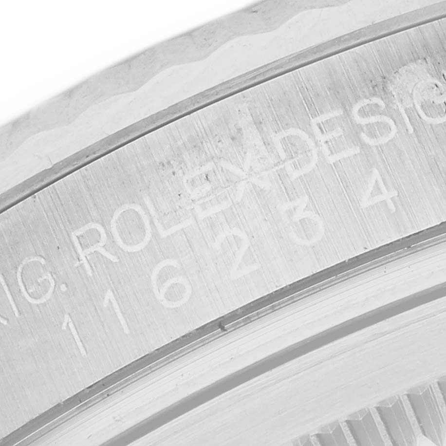 This image shows an up-close view of the engraved bezel of a Datejust model by Rolex.