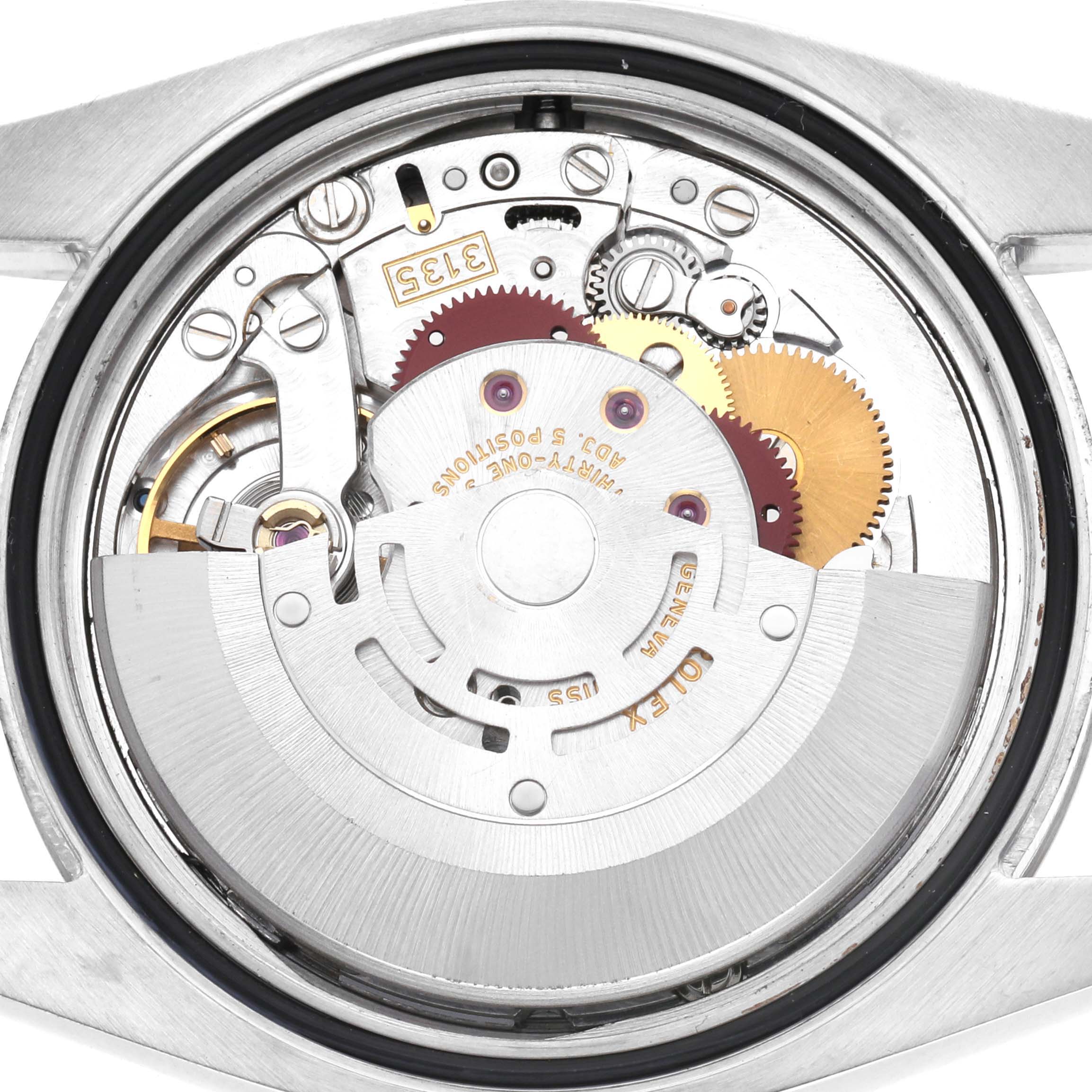 The image shows the back view of a Rolex Datejust 116234 Men's Stainless Steel Silver Dial 116234 Men's Stainless Steel Silver Dial, focusing on its intricate movement and gears.