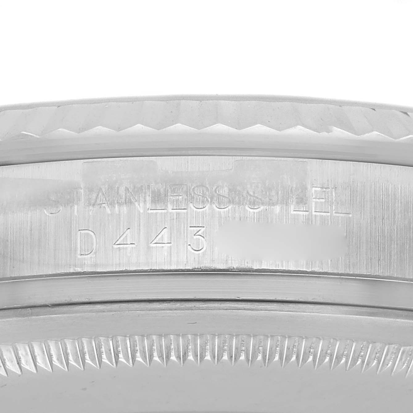 The image shows a close-up of the side of a Rolex Datejust 116234 Men's Stainless Steel Silver Dial 116234 Men's Stainless Steel Silver Dial case, highlighting the stainless steel marking and serial number.