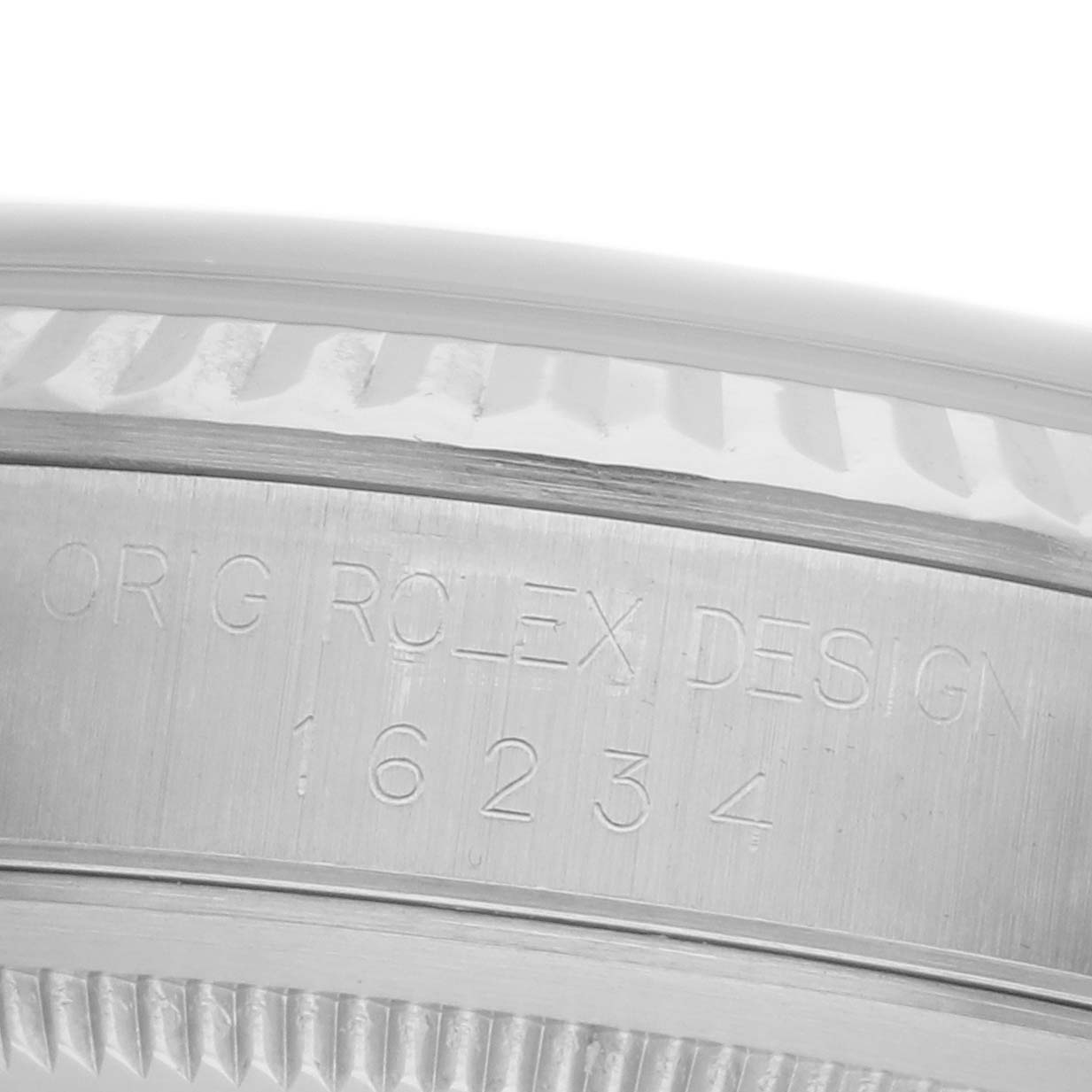 The image shows a close-up of the case side, serial number, and fluted bezel of a Rolex Datejust 16234 Men's Stainless Steel Silver Dial 16234 Men's Stainless Steel Silver Dial watch.
