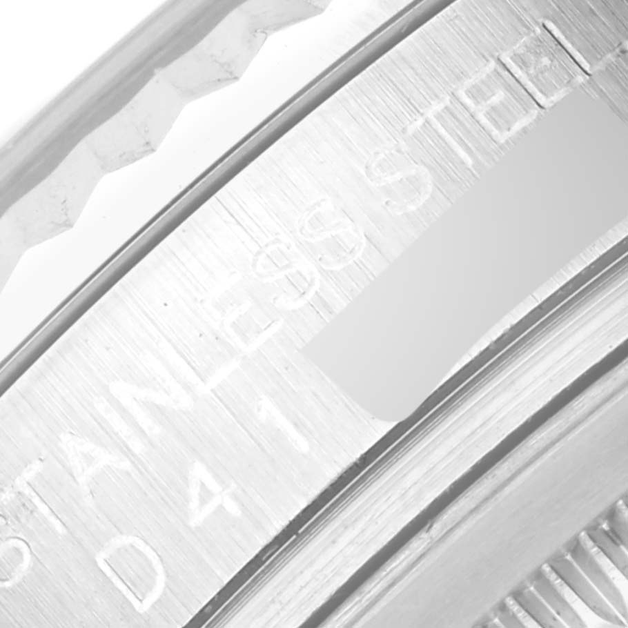This close-up image of a Rolex Datejust 116234 Men's Stainless Steel Silver Dial 116234 Men's Stainless Steel Silver Dial watch focuses on the stainless steel bezel and part of the case edge.