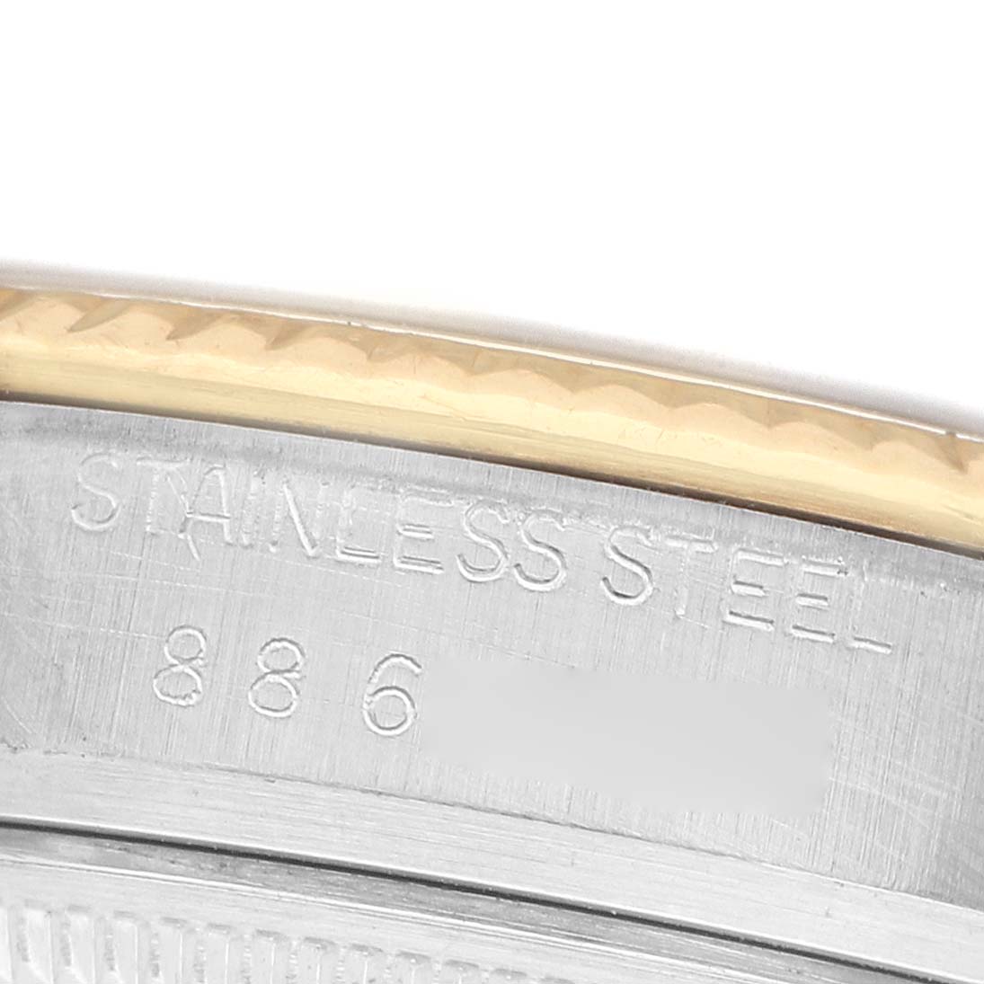 The image shows a close-up of the stainless steel case back edge and the fluted bezel of a Rolex Datejust 16013 Men's Steel and Gold (two tone) Champagne Dial watch.