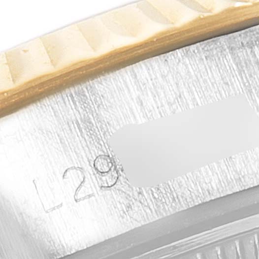 The image shows a close-up of the side of a Rolex Datejust 69173 Women's Steel and Gold (two tone) White Dial 69173 Women's Steel and Gold (two tone) White Dial watch, highlighting its bezel and part of the serial number.