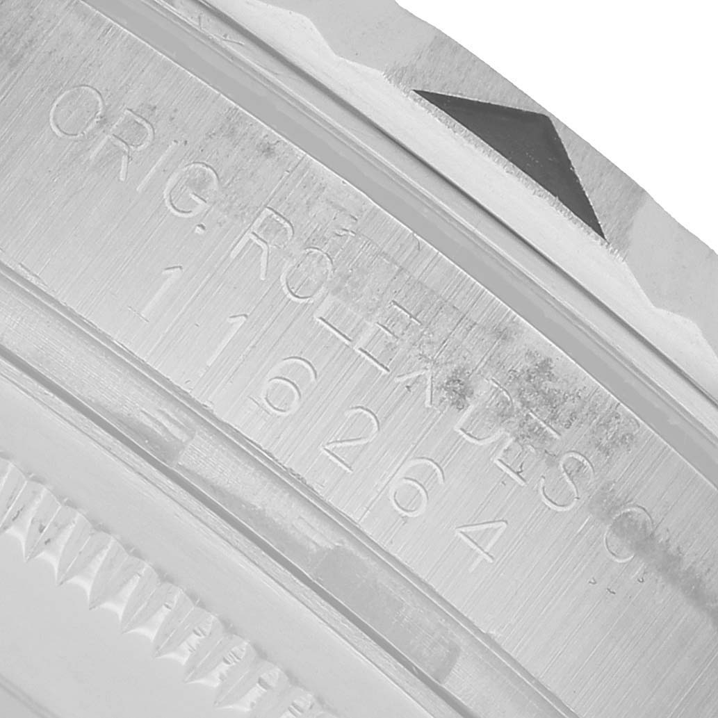 The image shows a close-up of the engraved bezel and part of the case of a Rolex Turn-o-Graph 116264 Men's Stainless Steel Blue Dial watch, displaying the model number.