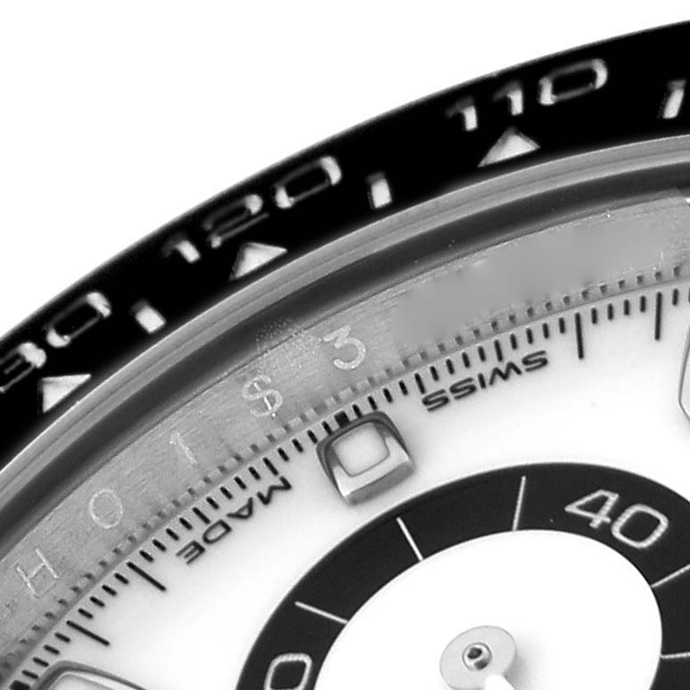 This close-up image of a Rolex Daytona 116500LN Men's Stainless Steel White Dial 116500LN Men's Stainless Steel White Dial watch shows the bezel and part of the dial with markers and numbers.