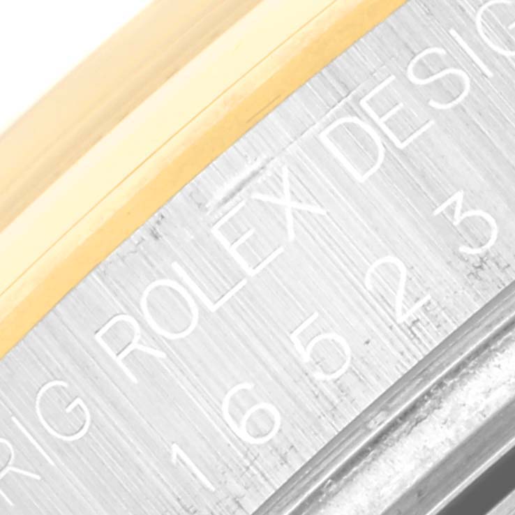 This image shows a close-up of the case side engraving on a Rolex Daytona 16523 Men's Steel and Gold (two tone) Champagne Dial 16523 Men's Steel and Gold (two tone) Champagne Dial watch.