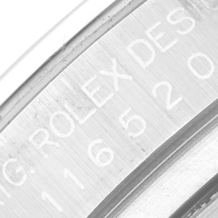 The image shows a close-up angle of the engraving on the inner bezel of a Rolex Daytona 116520 Men's Stainless Steel White Dial 116520 Men's Stainless Steel White Dial watch.
