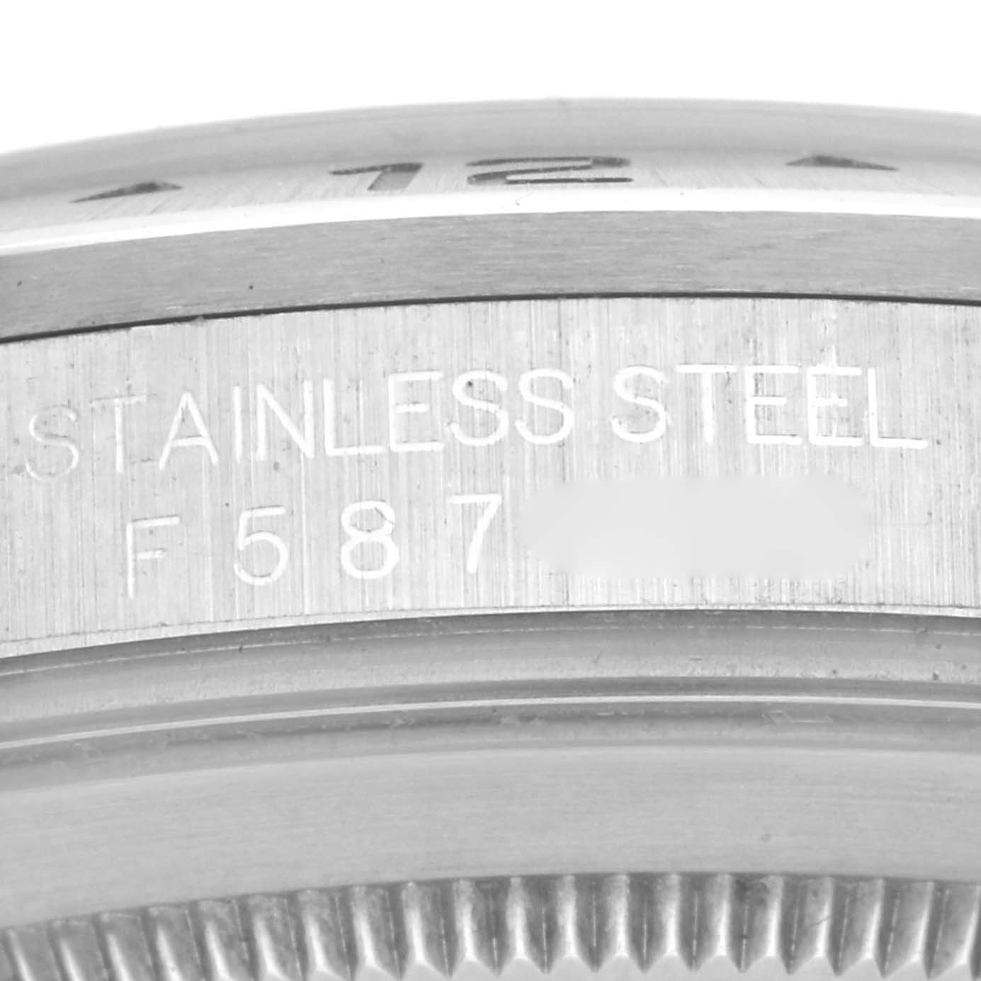 This image shows a close-up of the side engravings on a Rolex Explorer 16570 Men
s Stainless Steel Black Dial 16570 Men
s Stainless Steel Black Dial watch, highlighting the serial number and "STAINLESS STEEL" text.