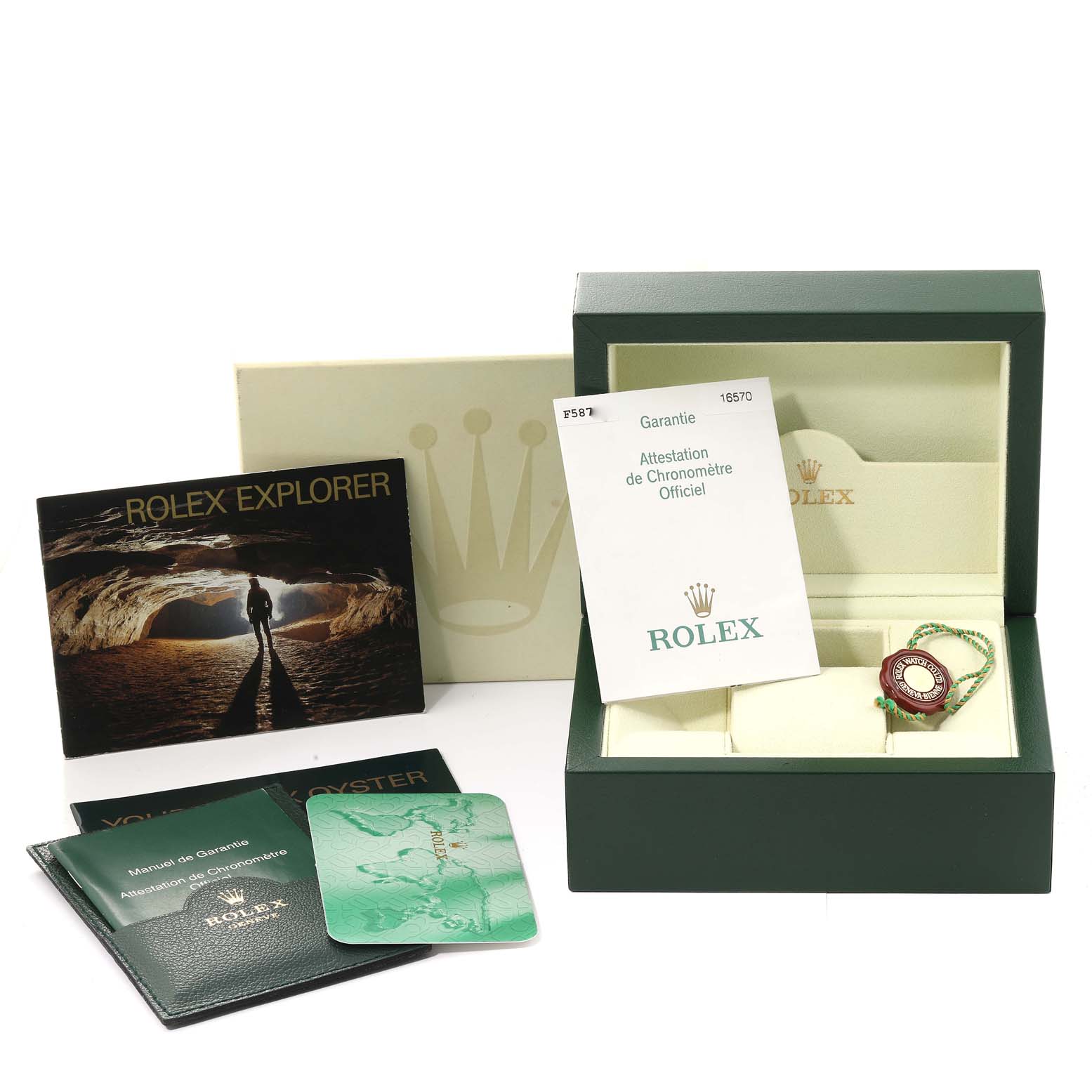 The image shows a Rolex Explorer 16570 Men
s Stainless Steel Black Dial 16570 Men
s Stainless Steel Black Dial watch box, manuals, warranty card, and a Rolex tag from a front view.