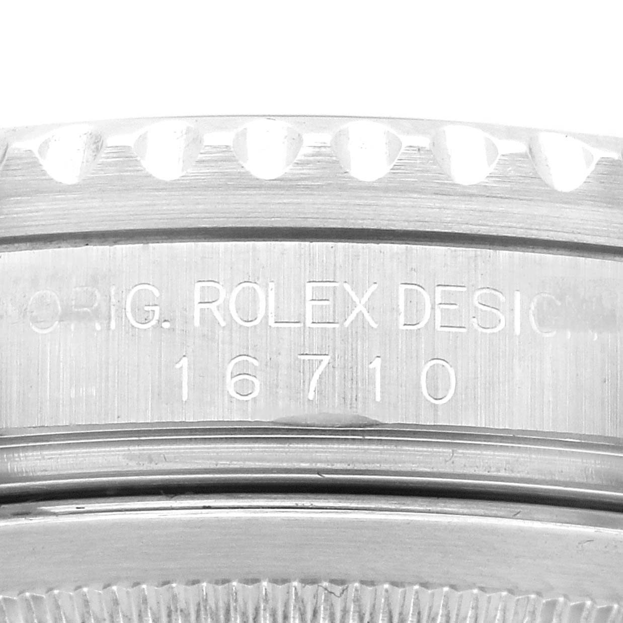 This image shows a close-up of the side of the watch case of a Rolex GMT-Master 16710 Men's Stainless Steel Black Dial 16710 Men's Stainless Steel Black Dial, focusing on the engraved model number "16710".