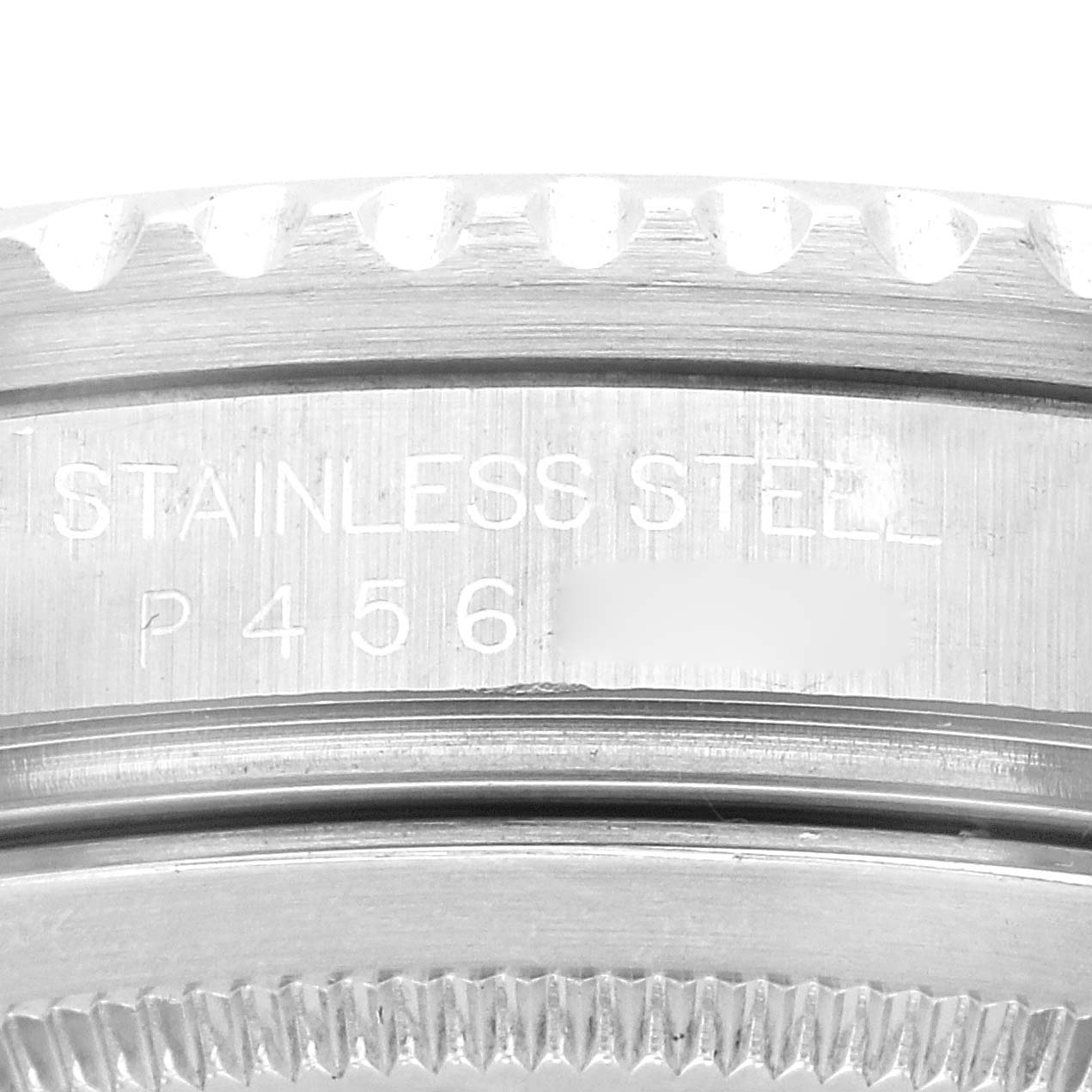 This image shows a close-up of the side of a Rolex GMT-Master 16710 Men's Stainless Steel Black Dial 16710 Men's Stainless Steel Black Dial watch, highlighting the stainless steel marking and part of the bezel.