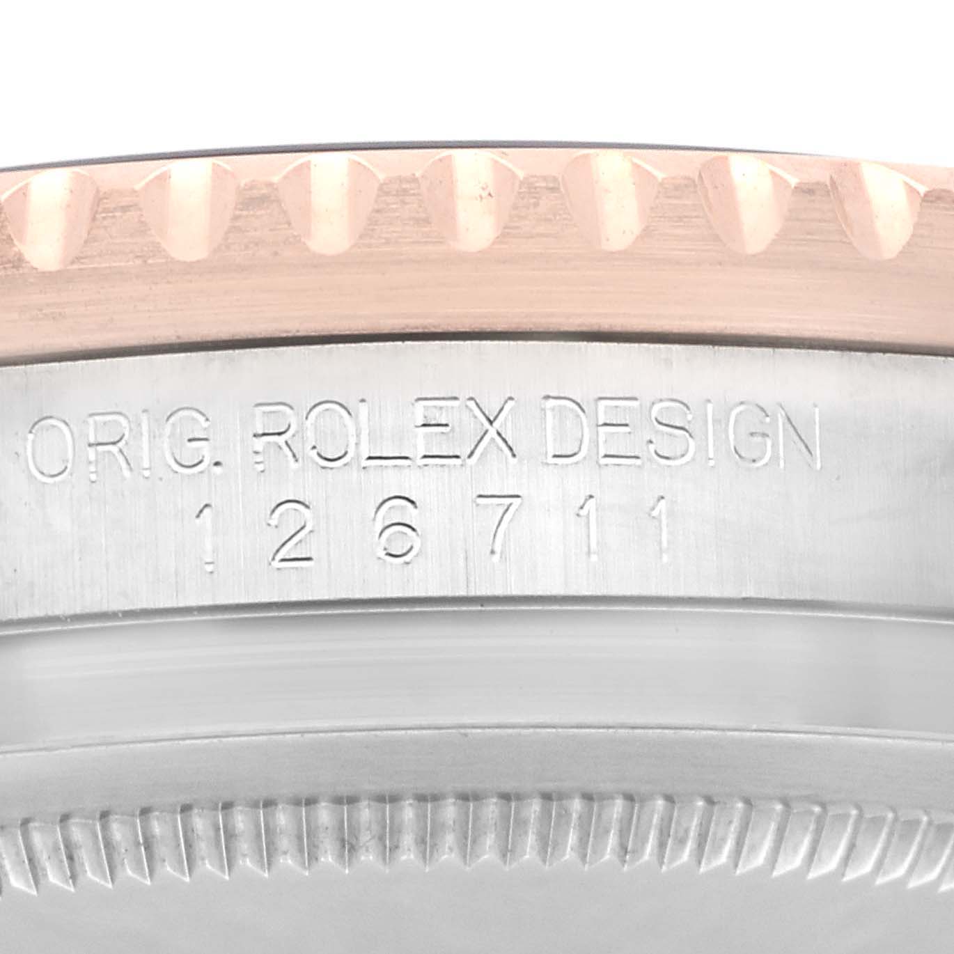 The image shows a close-up of the side of a Rolex GMT-Master 126711CHNR Men
s Steel and Gold (two tone) Black Dial 126711CHNR Men
s Steel and Gold (two tone) Black Dial watch, highlighting the model number and part of the bezel.