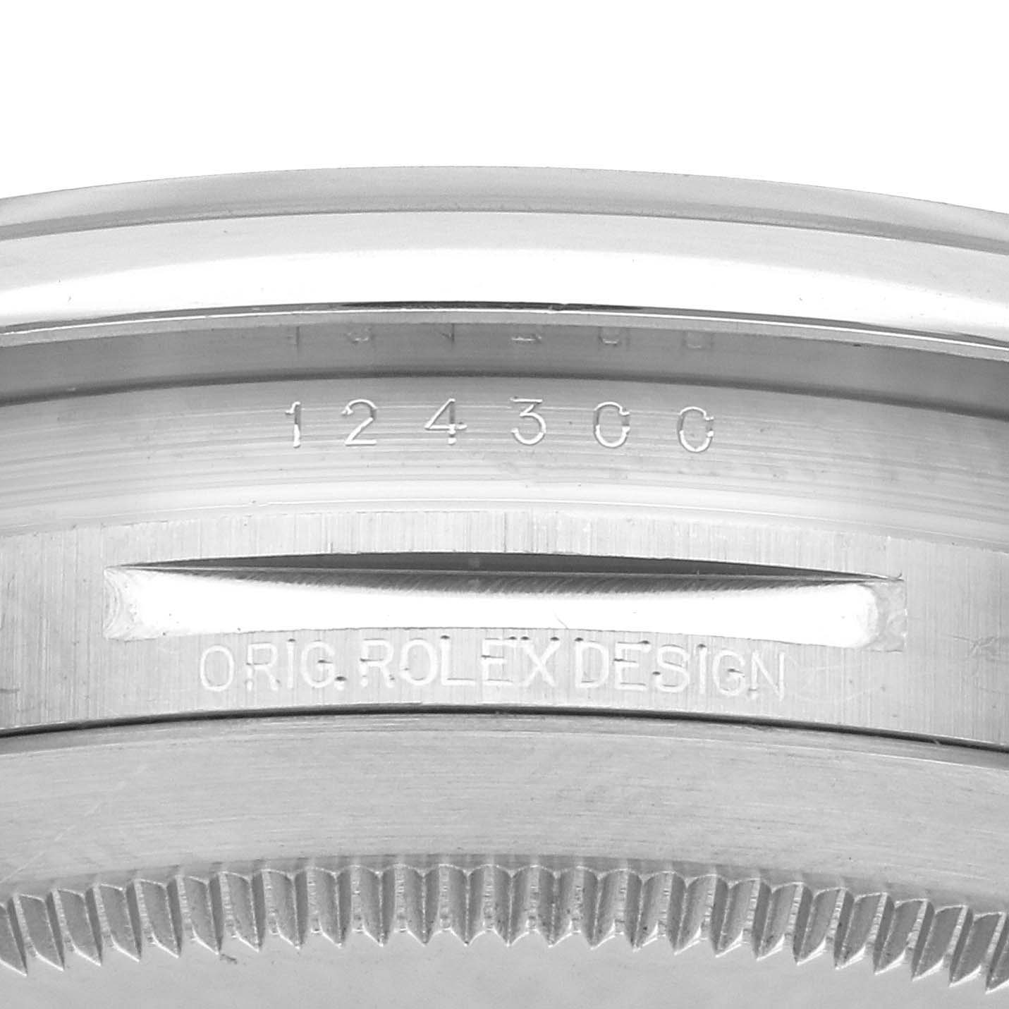 The image shows the side view of a Rolex Oyster Perpetual 124300 Men's Stainless Steel Black Dial 124300 Men's Stainless Steel Black Dial watch case, focusing on the engraved reference number and "ORIG. ROLEX DESIGN."