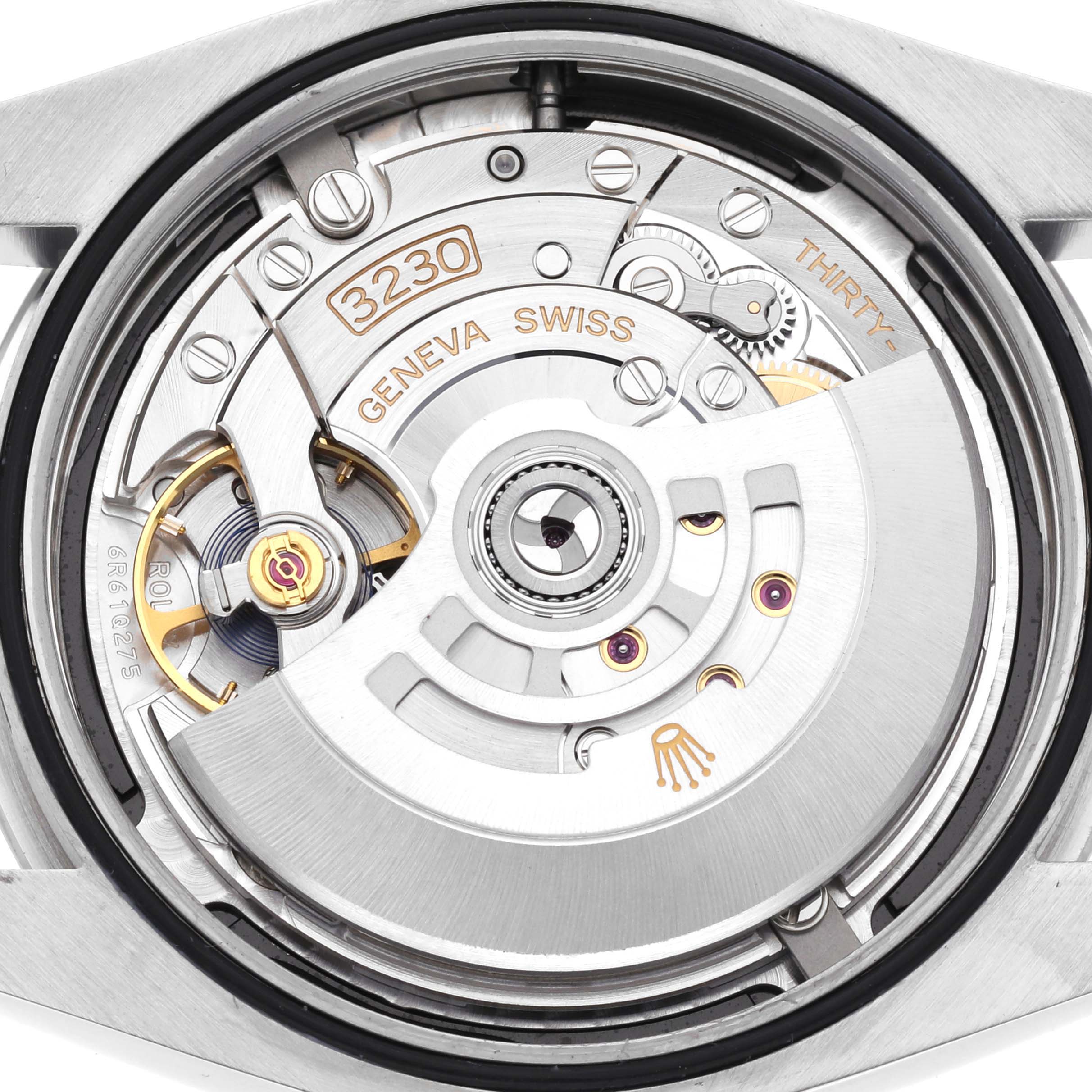 The image shows the internal movement of a Rolex Oyster Perpetual 124300 Men's Stainless Steel Black Dial 124300 Men's Stainless Steel Black Dial watch from the back, highlighting the rotor and gears.