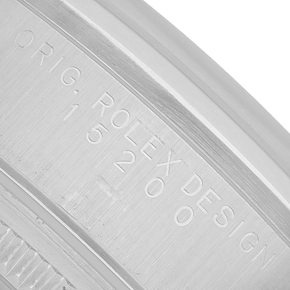 The image shows a close-up of the engraving on the case side of a Rolex Oyster Perpetual 15200 Men's Stainless Steel Black Dial watch.