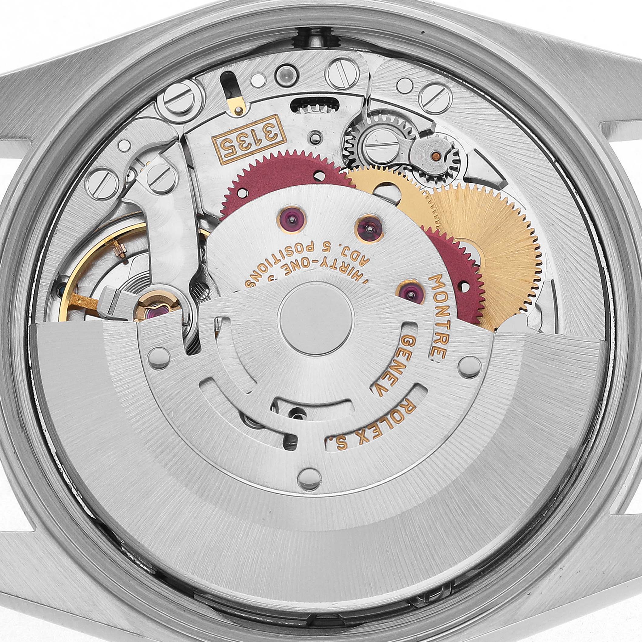 The image shows the movement of a Rolex Oyster Perpetual 15200 Men's Stainless Steel Black Dial watch, highlighting gears and mechanical components from the back.