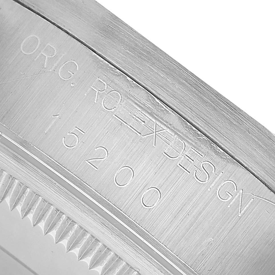 The image shows a close-up of the side edge of a Rolex Oyster Perpetual 15200 Men's Stainless Steel Silver Dial watch case with engraved details.